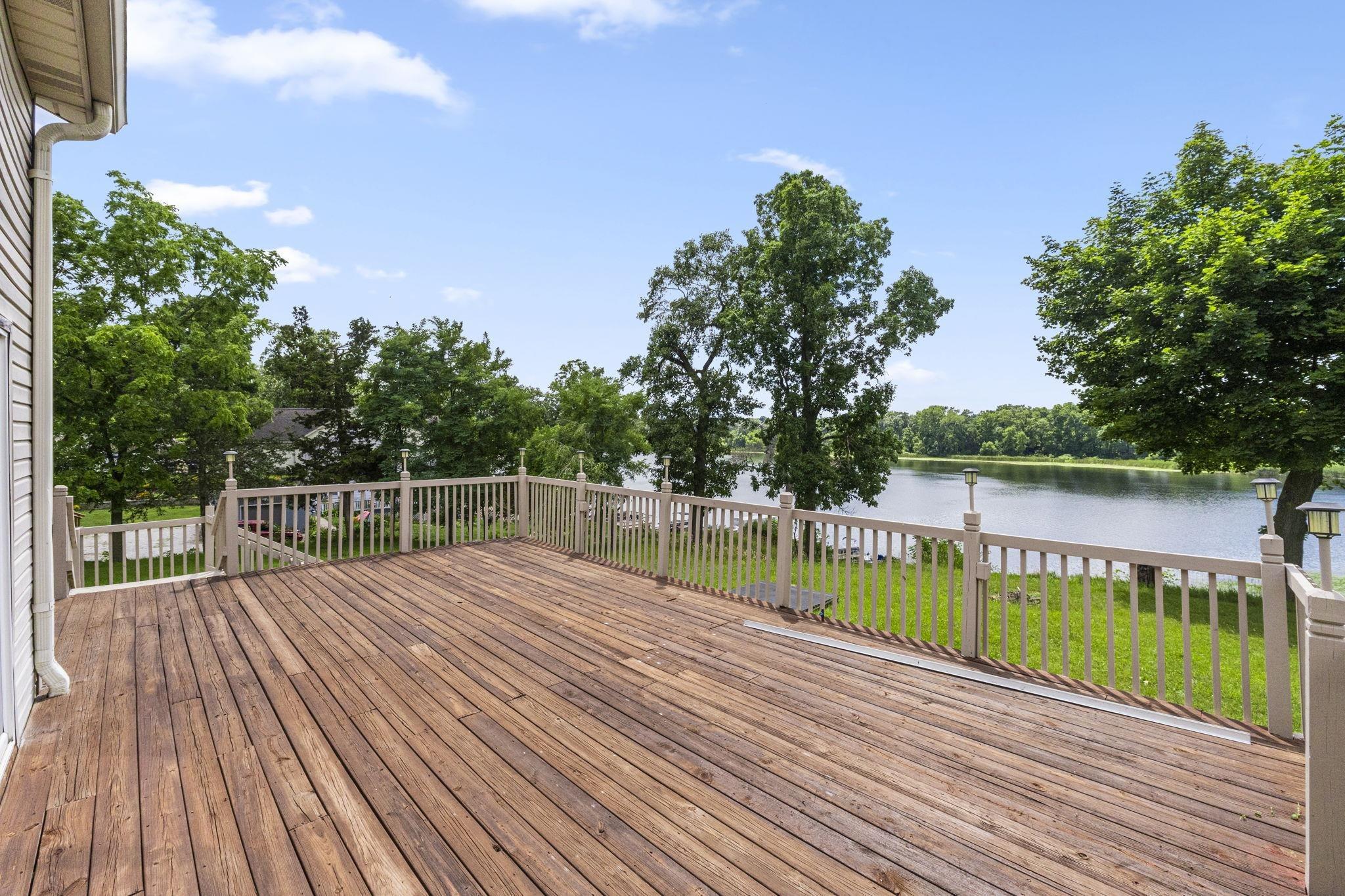Image 2: Deck with a water view and a yard, Deck