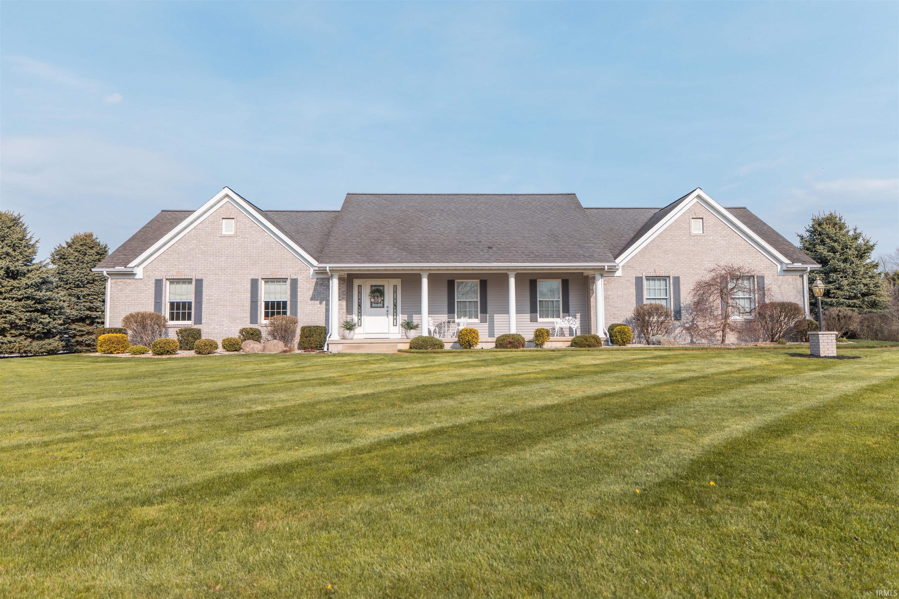 Image 0: View of front of property with covered porch, a front lawn, and brick siding, Front Of Structure
