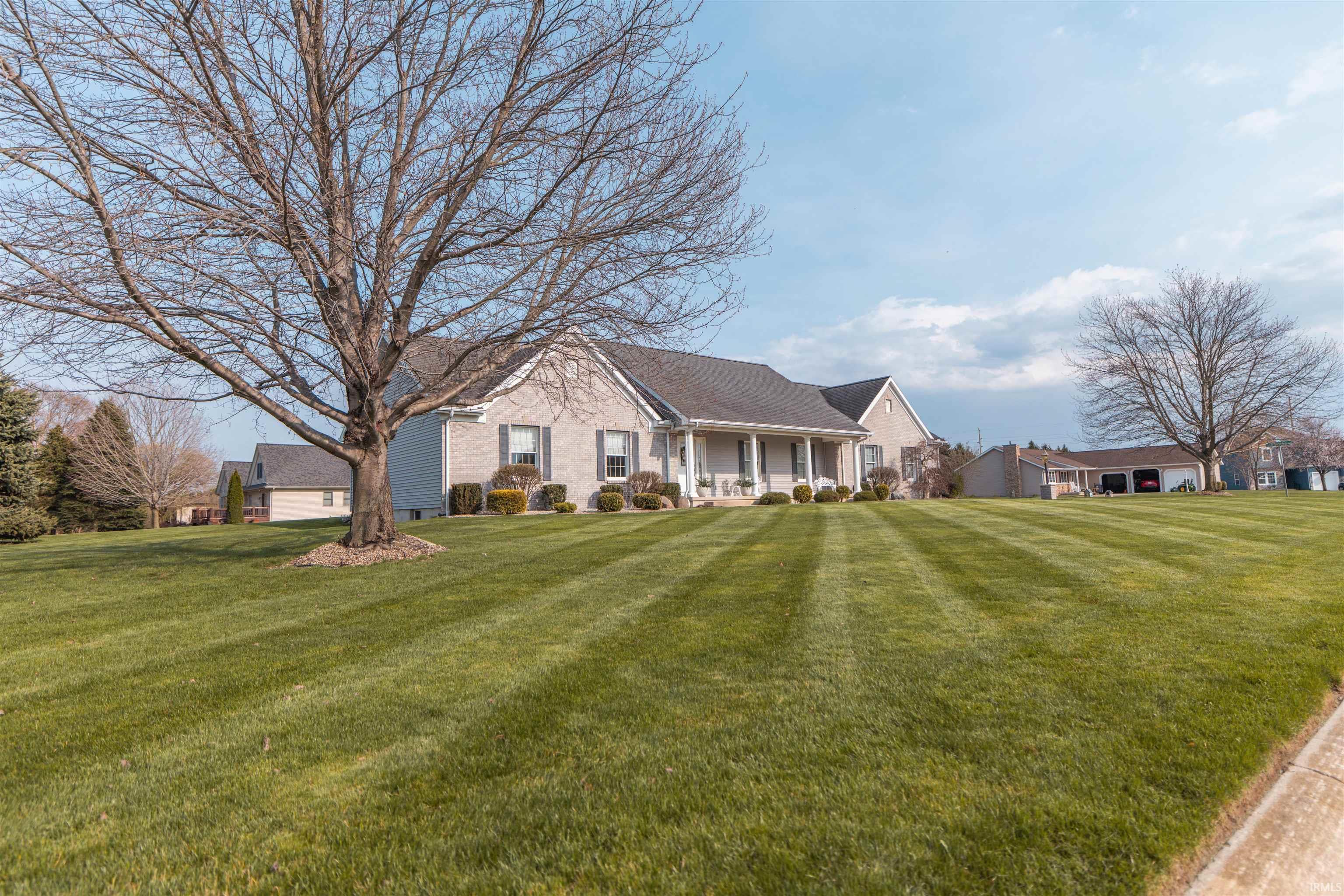 Image 1: View of front facade featuring covered porch, a front yard, and a residential view, Front Of Structure