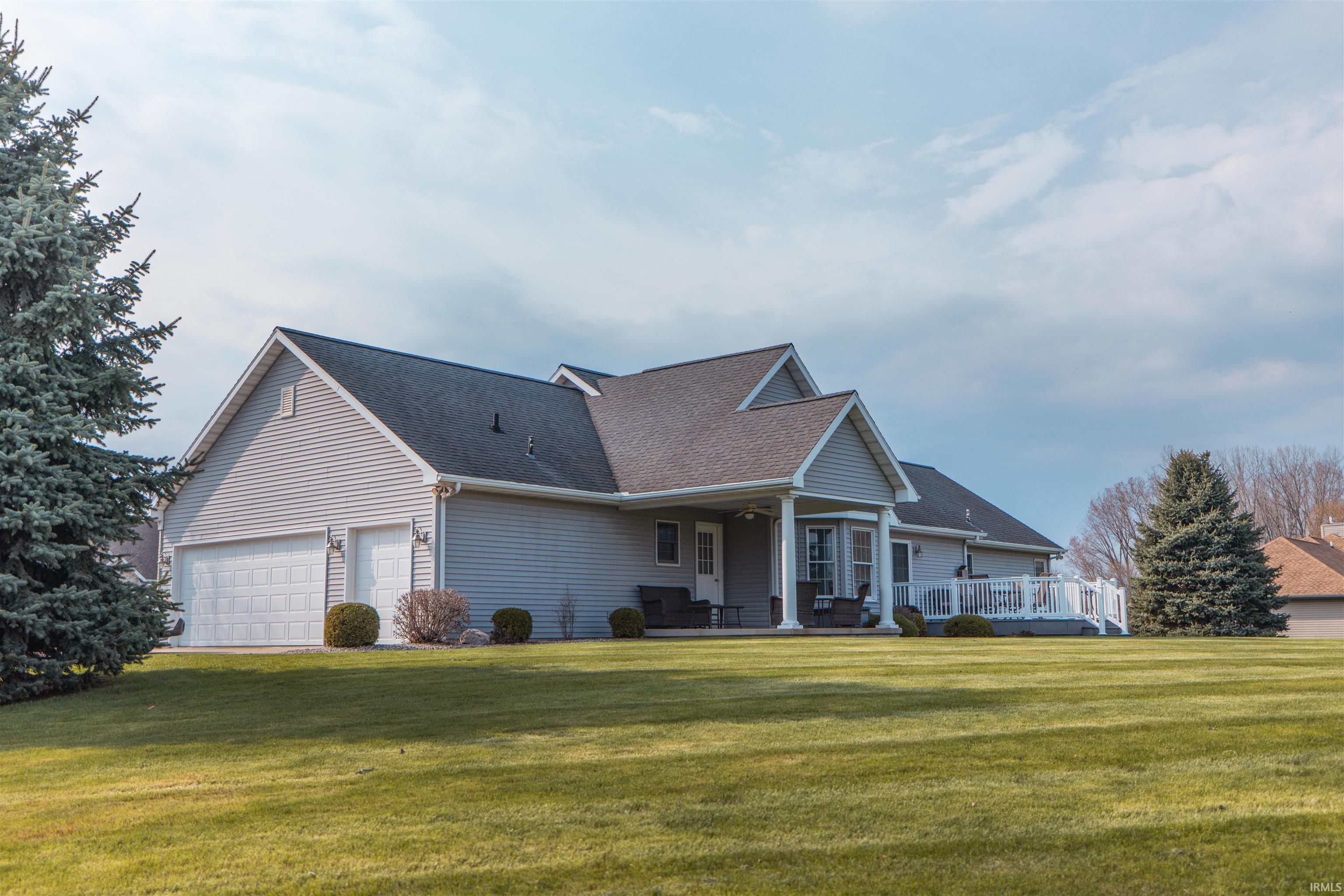 Image 2: View of front of home featuring a front yard, a porch, a shingled roof, and a garage, Front Of Structure