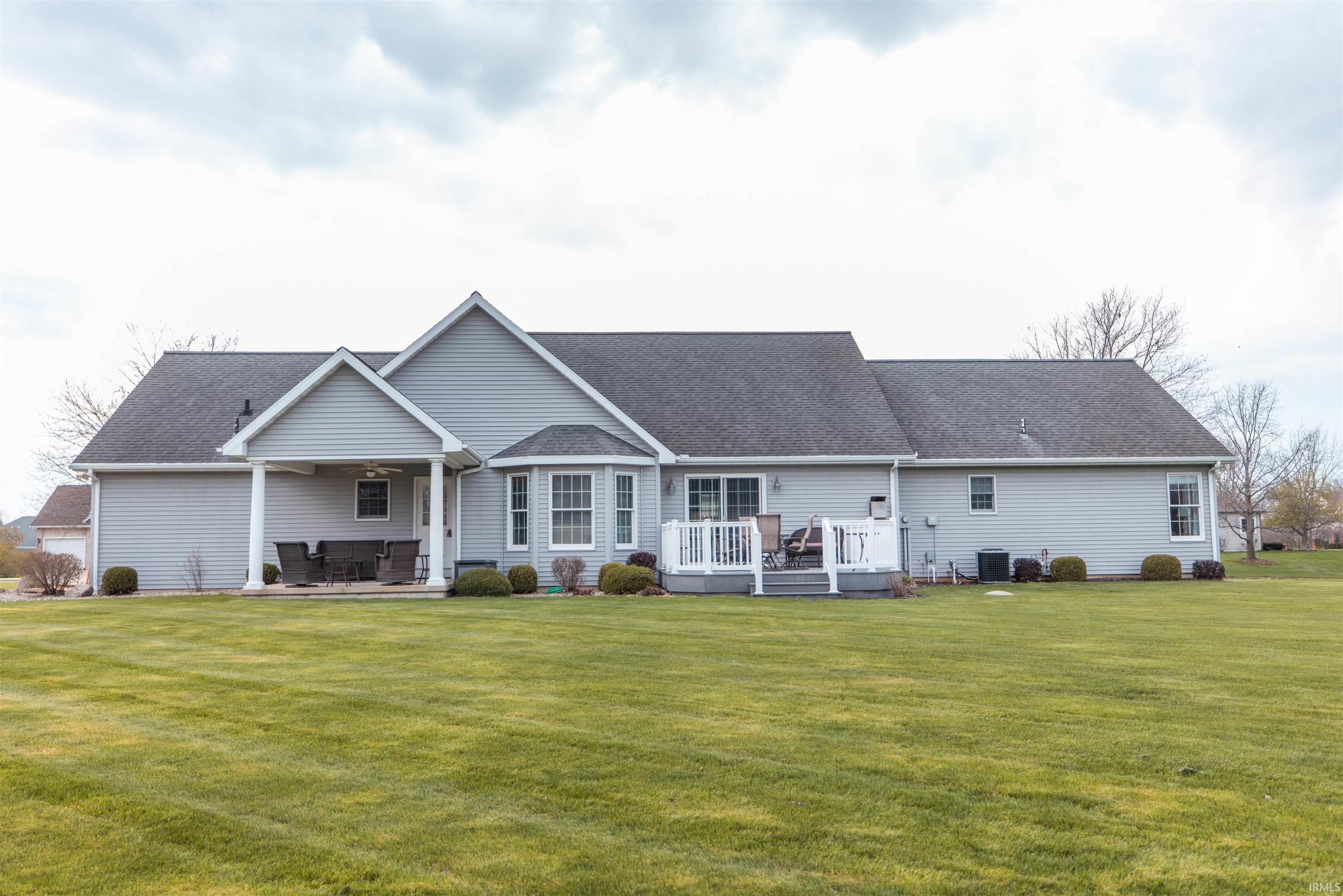 Image 3: Back of house with a deck, a lawn, and roof with shingles, Back Of Structure