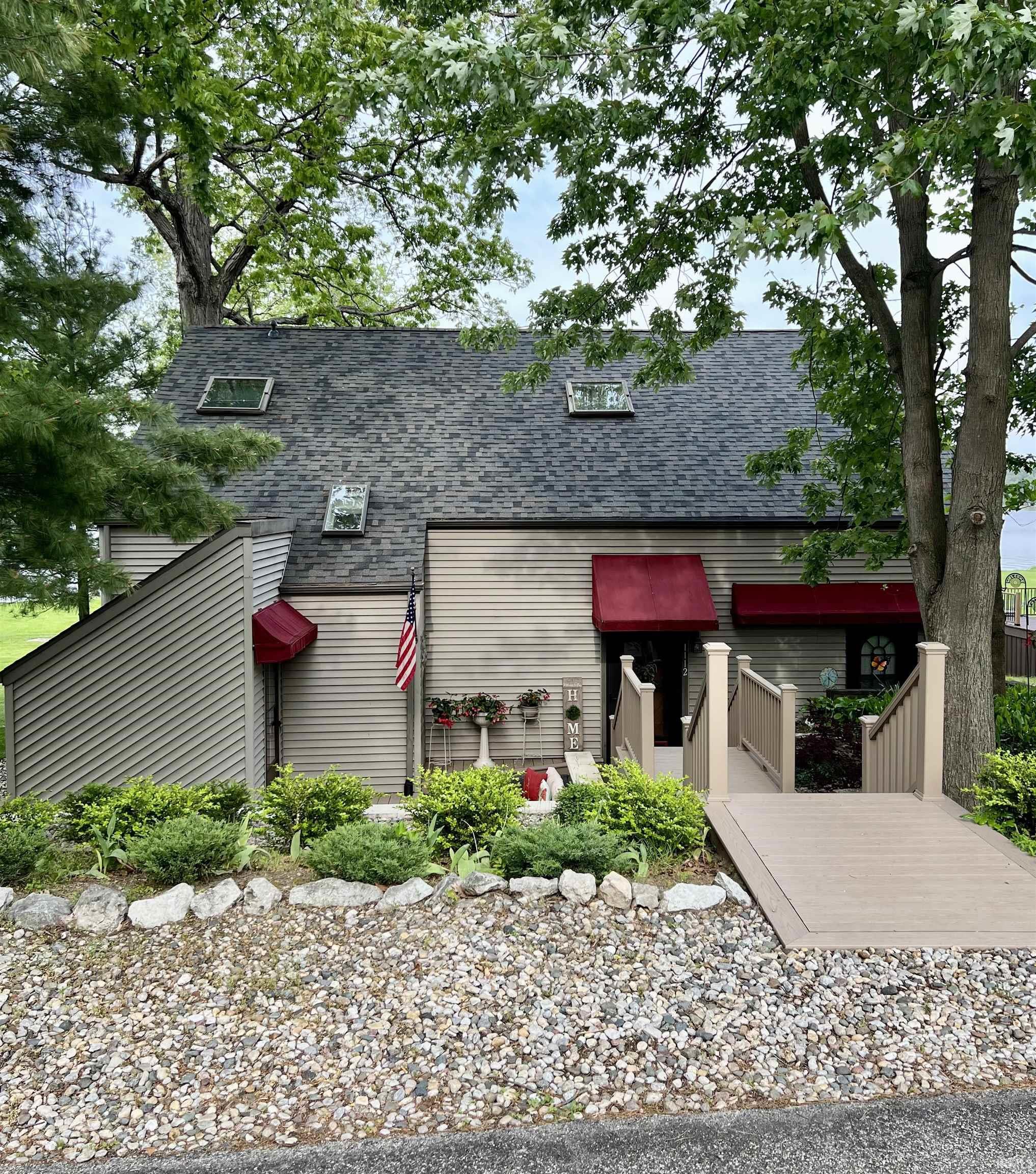 Image 0: Multi-level exterior with horizontal siding, a dark shingle roof, and three skylights, Front Of Structure Image 0: Multi-level exterior with horizontal siding, a dark shingle roof, and three skylights, Front Of Structure