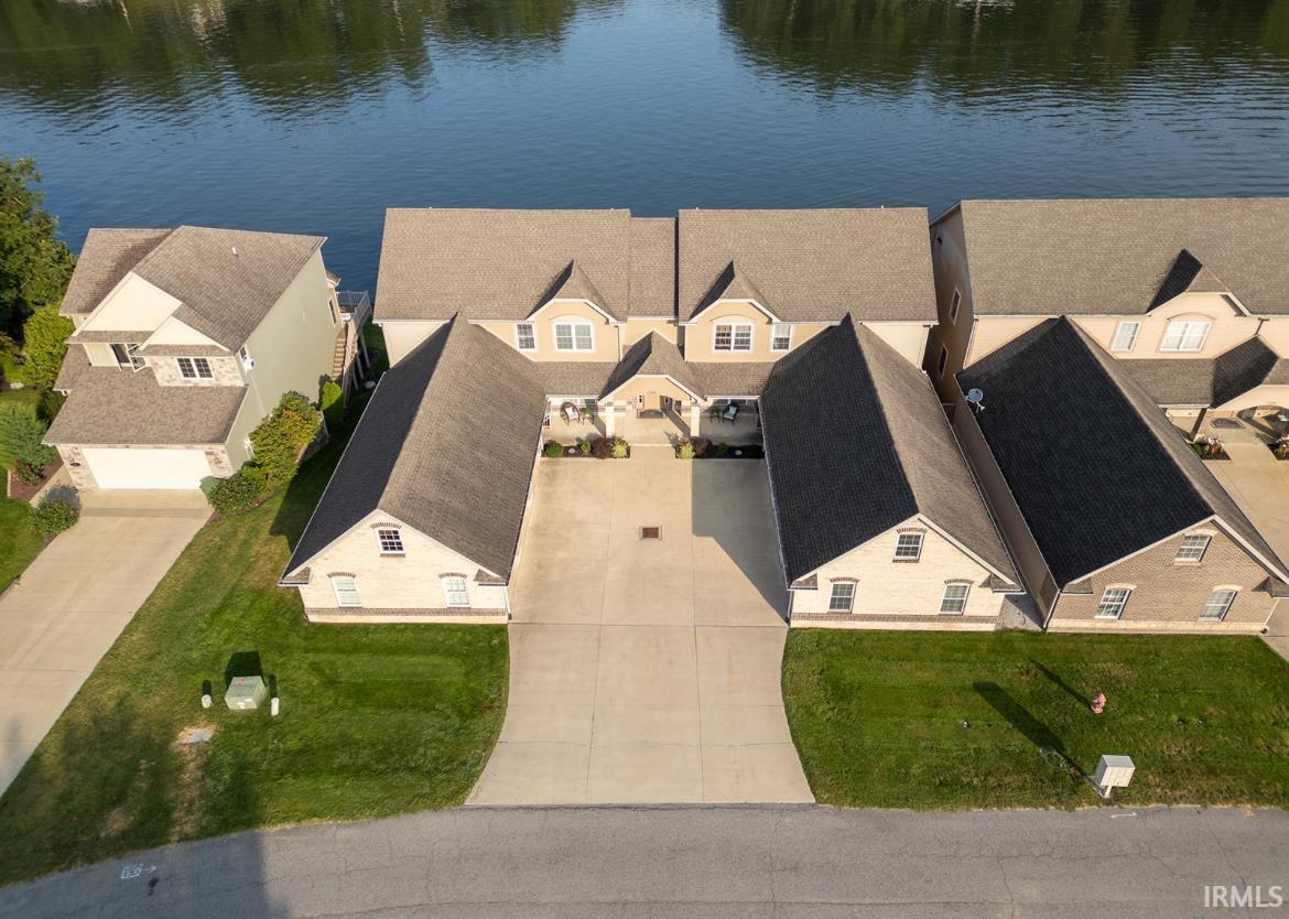 Image 1: Aerial perspective of suburban area with a nearby body of water, Aerial View Image 1: Aerial perspective of suburban area with a nearby body of water, Aerial View