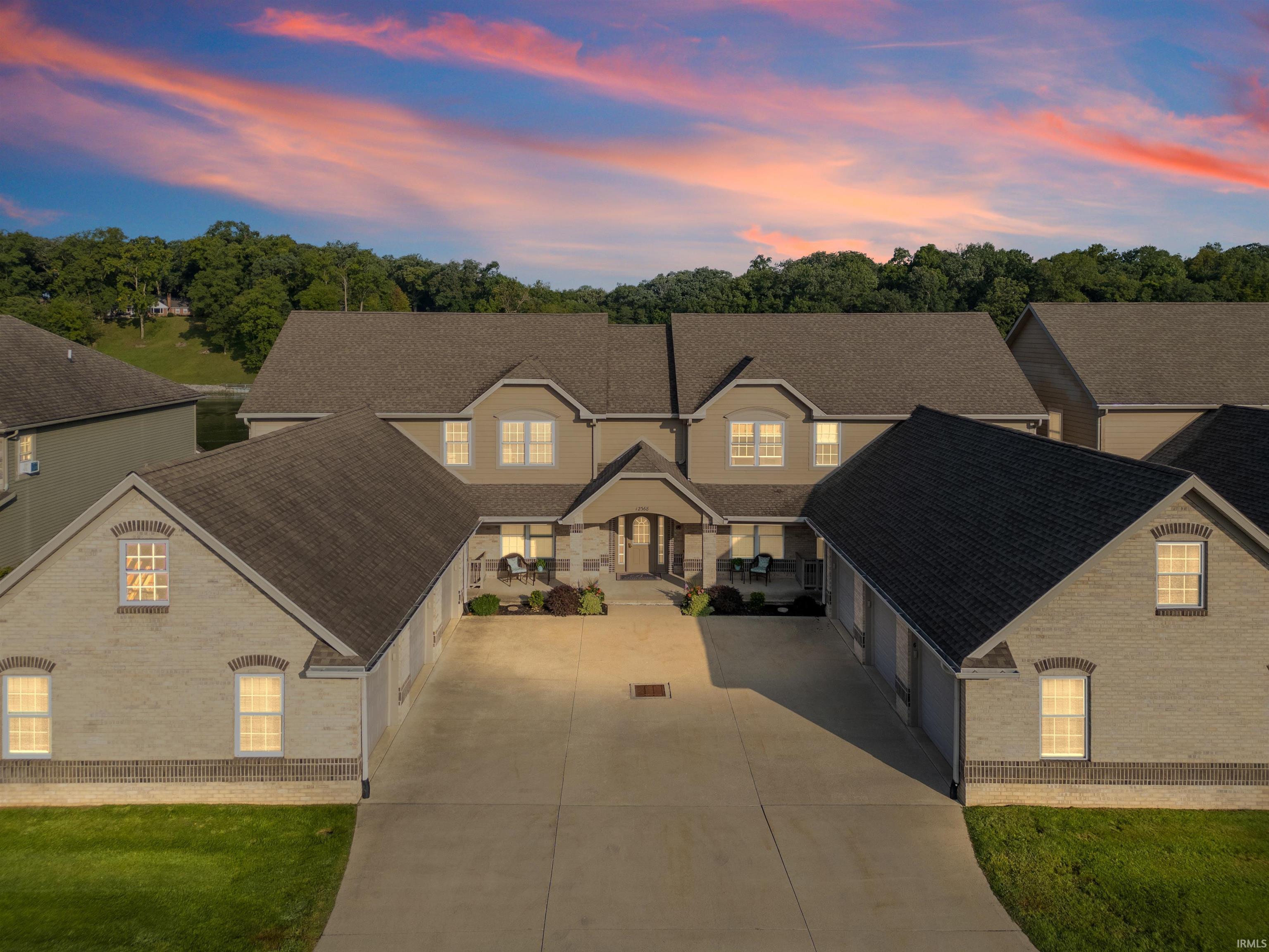 Image 3: View of front of home featuring a shingled roof, driveway, brick siding, covered porch, and a garage, Front Of Structure Image 3: View of front of home featuring a shingled roof, driveway, brick siding, covered porch, and a garage, Front Of Structure