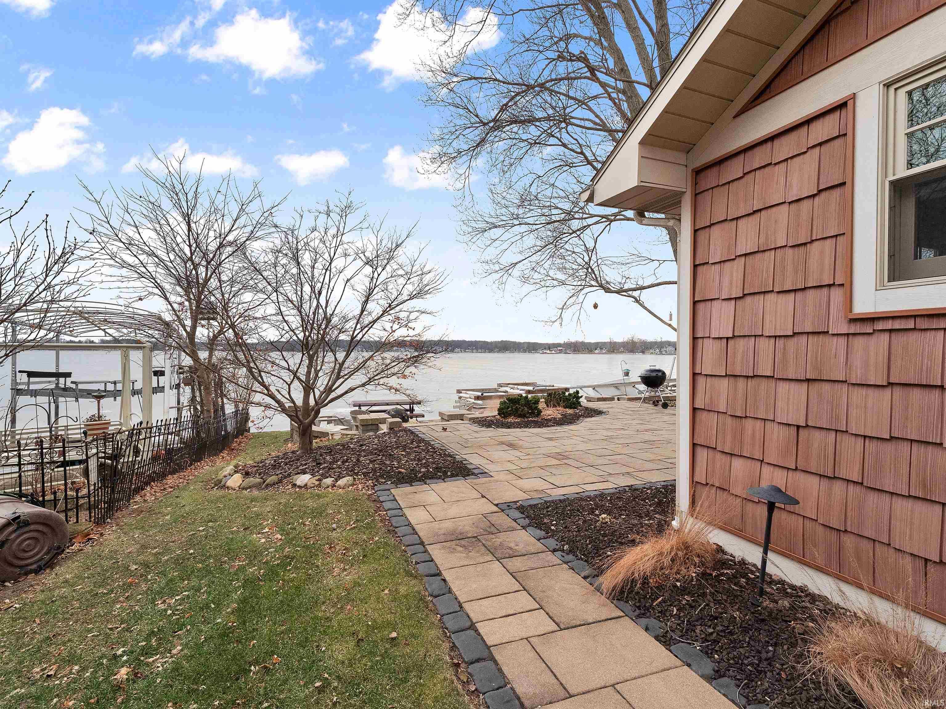 Image 3: View of yard featuring a water view and a patio area, Yard