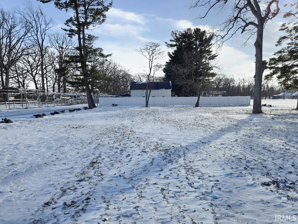 Image 0: View of yard covered in snow, Yard