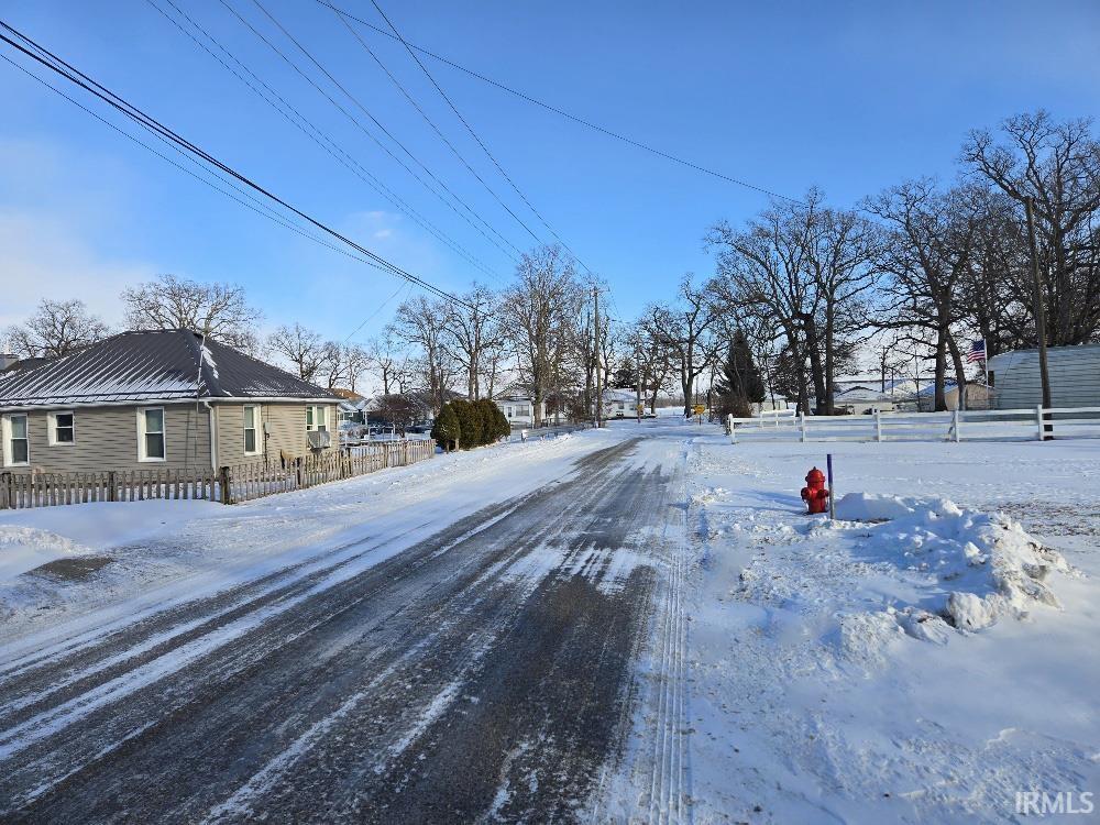 Image 1: View of asphalt road featuring a residential view, Community