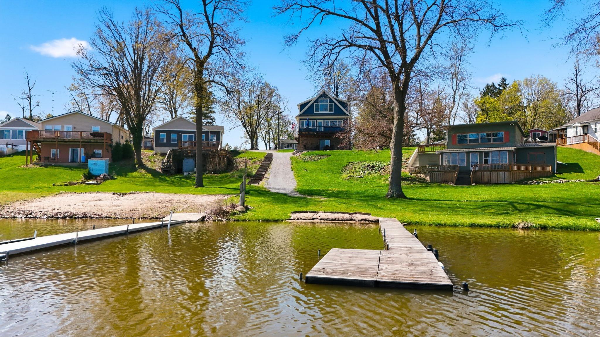 Image 1: Dock featuring a lawn, a residential view, and a deck with water view, Dock