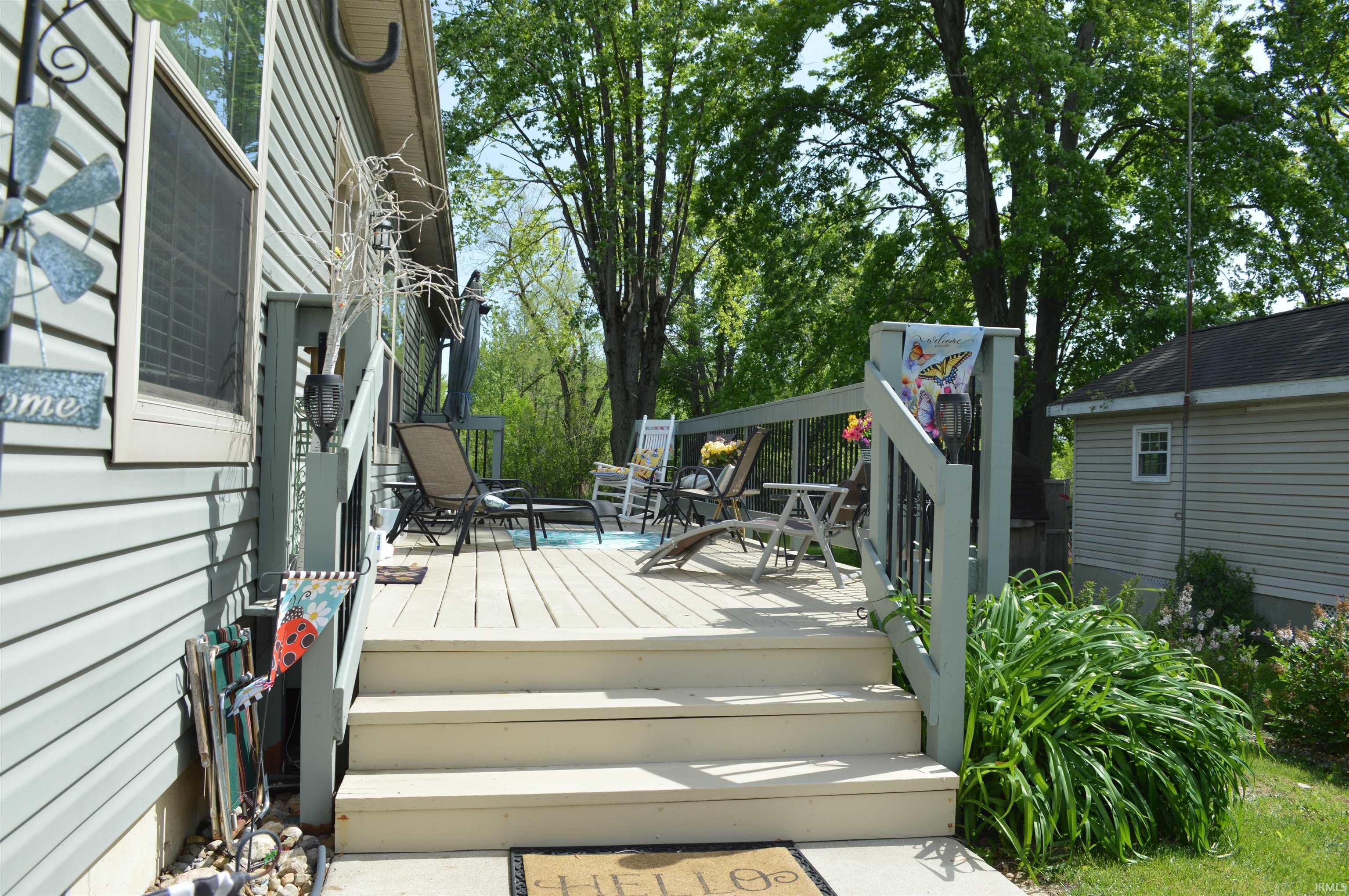Image 1: Spacious outdoor deck with railings and steps, featuring wood-finish decking and surrounded by mature trees, Deck Image 1: Spacious outdoor deck with railings and steps, featuring wood-finish decking and surrounded by mature trees, Deck