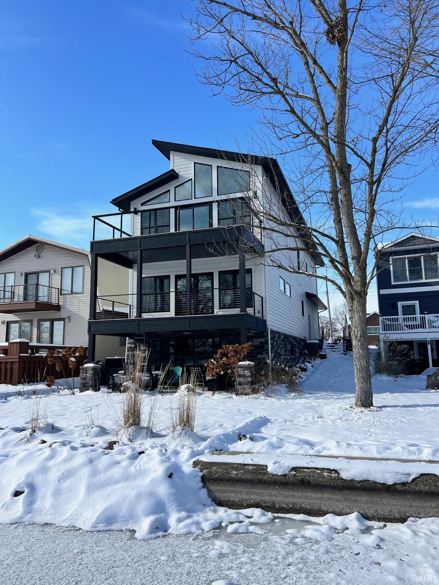 Image 0: View of front of property with a balcony, Front Of Structure