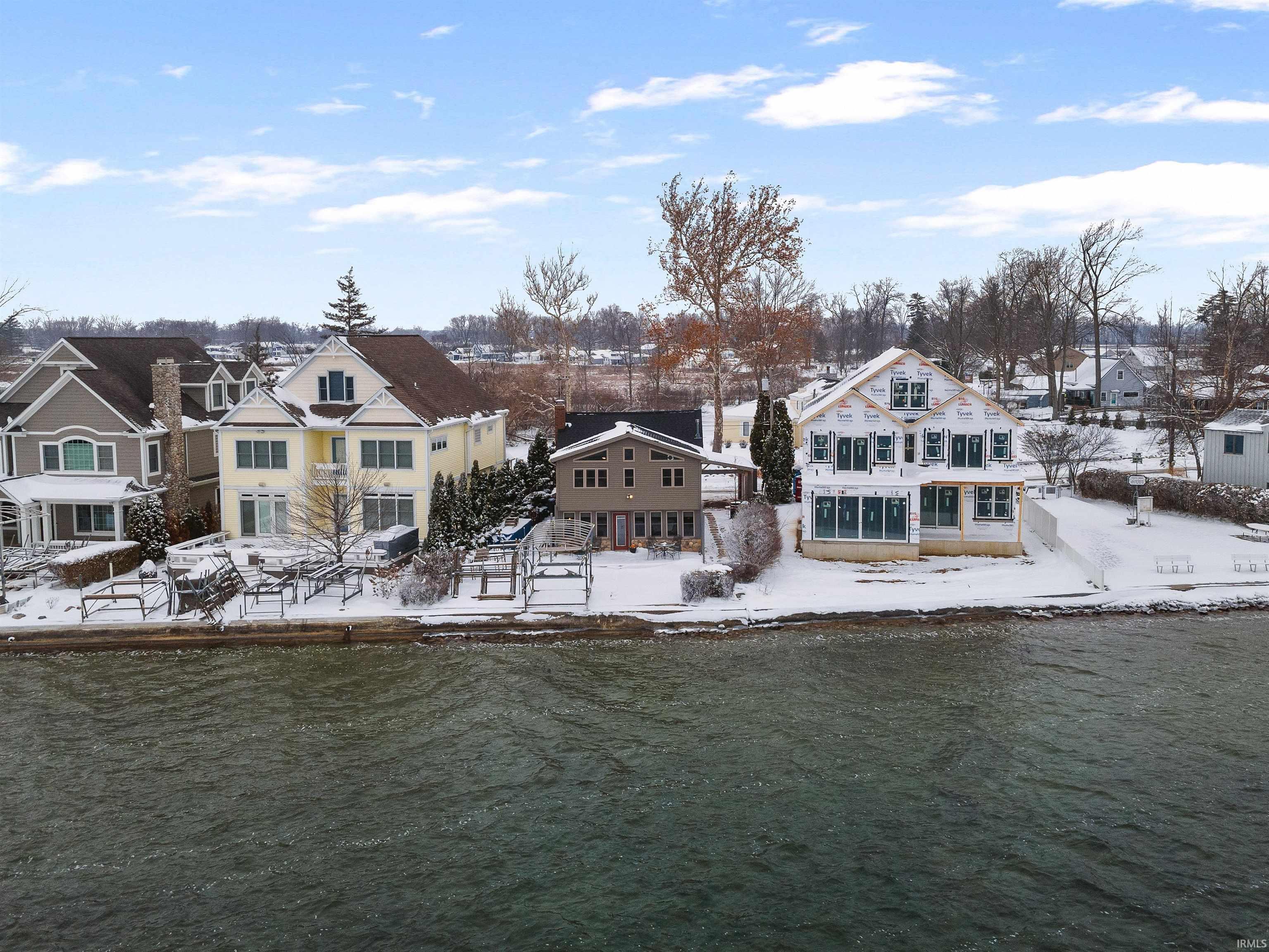 Image 1: Snow covered rear of property featuring a residential view and a water view, Back Of Structure Image 1: Snow covered rear of property featuring a residential view and a water view, Back Of Structure