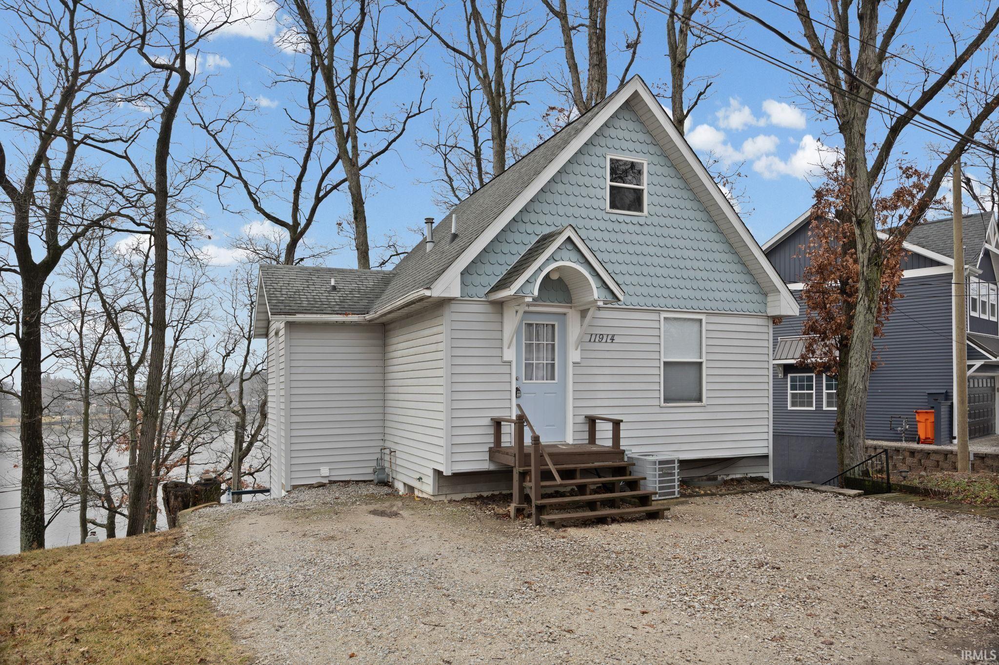 Image 1: View of front of home featuring roof with shingles, Front Of Structure