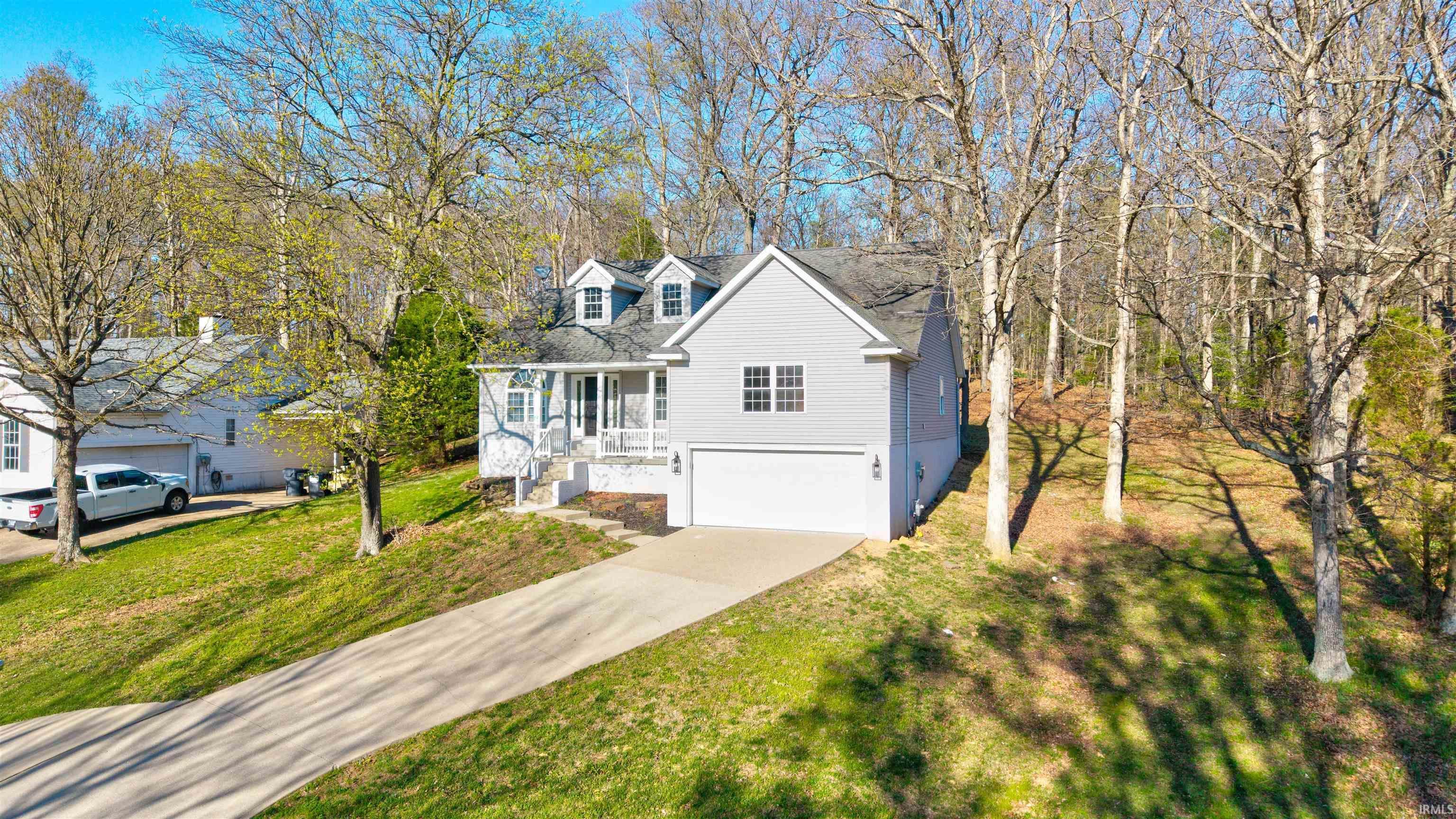 Image 1: View of front of home featuring a garage, concrete driveway, and a front yard, Front Of Structure Image 1: View of front of home featuring a garage, concrete driveway, and a front yard, Front Of Structure