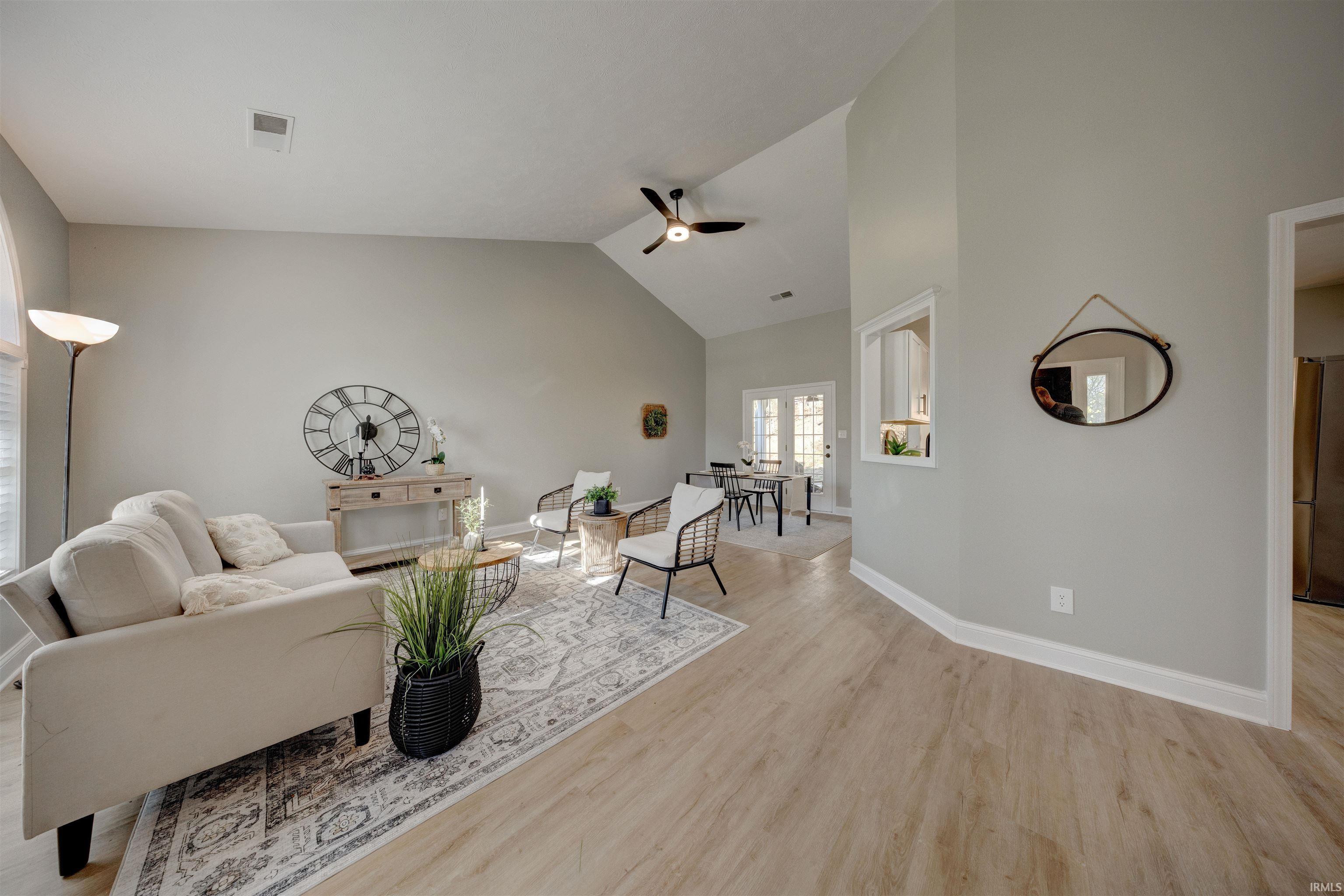 Image 3: Living room with lofted ceiling, ceiling fan, and light wood-type flooring, Living Room Image 3: Living room with lofted ceiling, ceiling fan, and light wood-type flooring, Living Room
