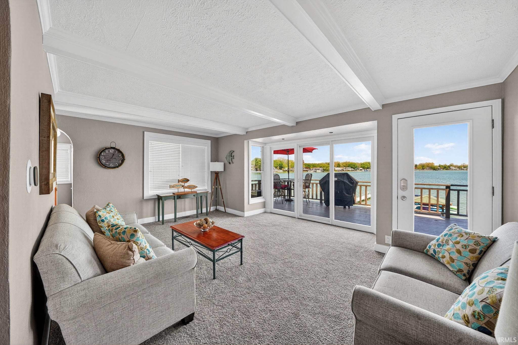 Image 1: Living area featuring large sliding glass doors and a full-light door leading to an outdoor deck, Living Room