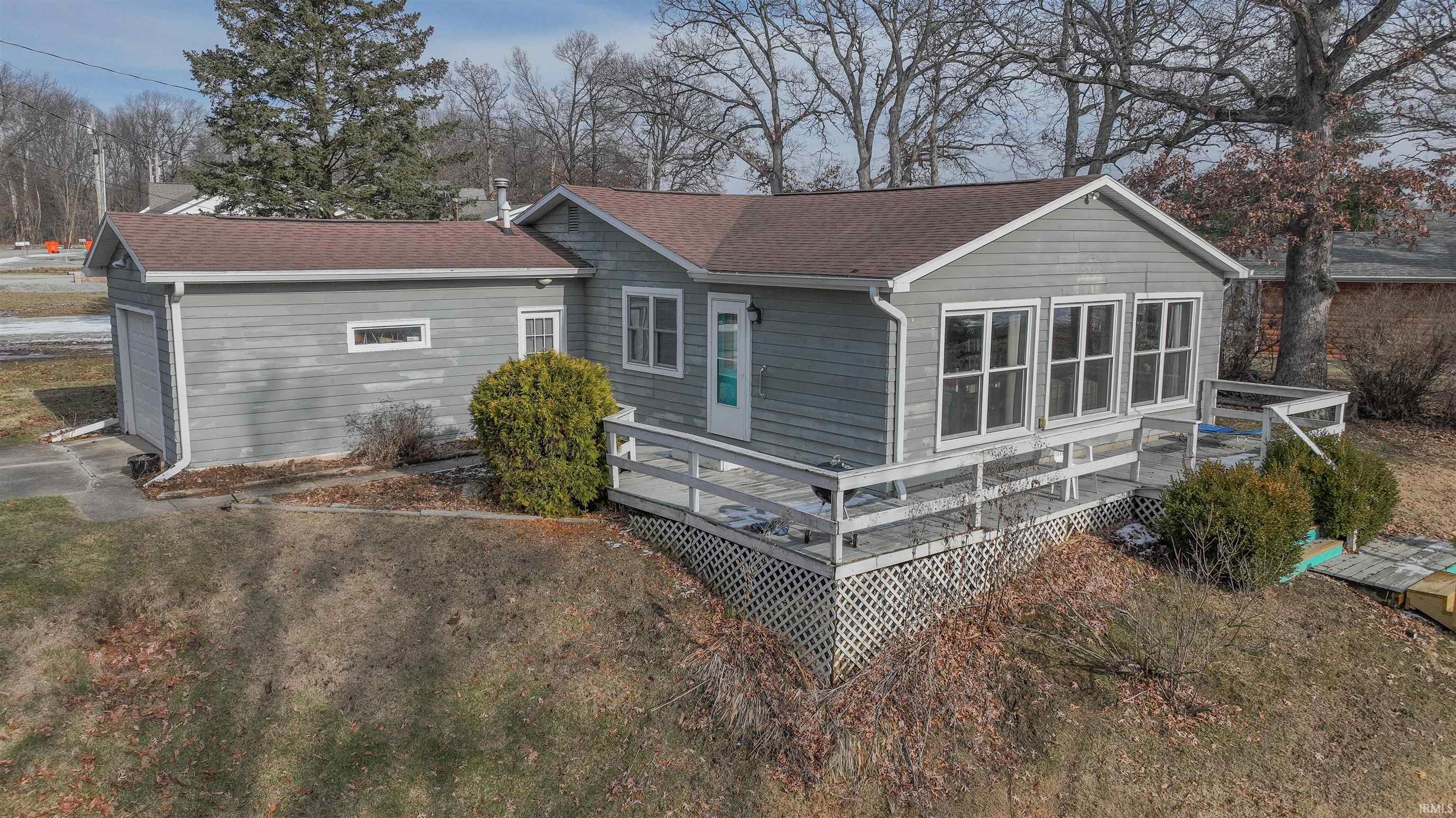 Image 1: Rear view of property featuring a deck and roof with shingles, Back Of Structure Image 1: Rear view of property featuring a deck and roof with shingles, Back Of Structure