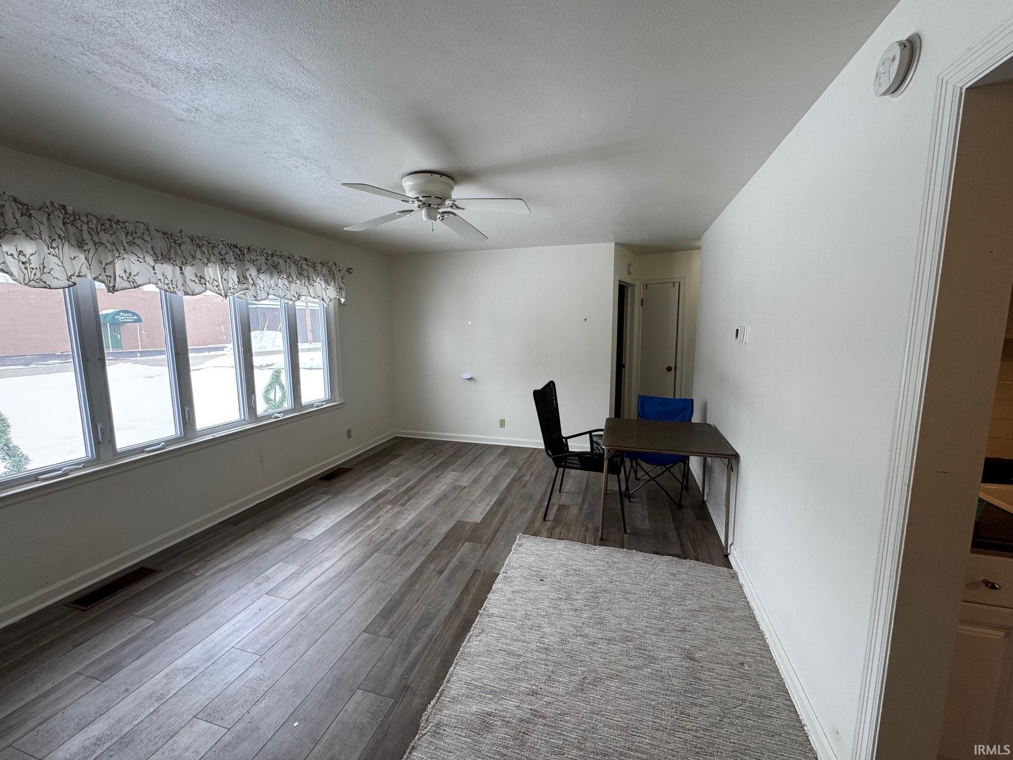 Image 3: Unfurnished office featuring ceiling fan, wood finished floors, and a textured ceiling, Office