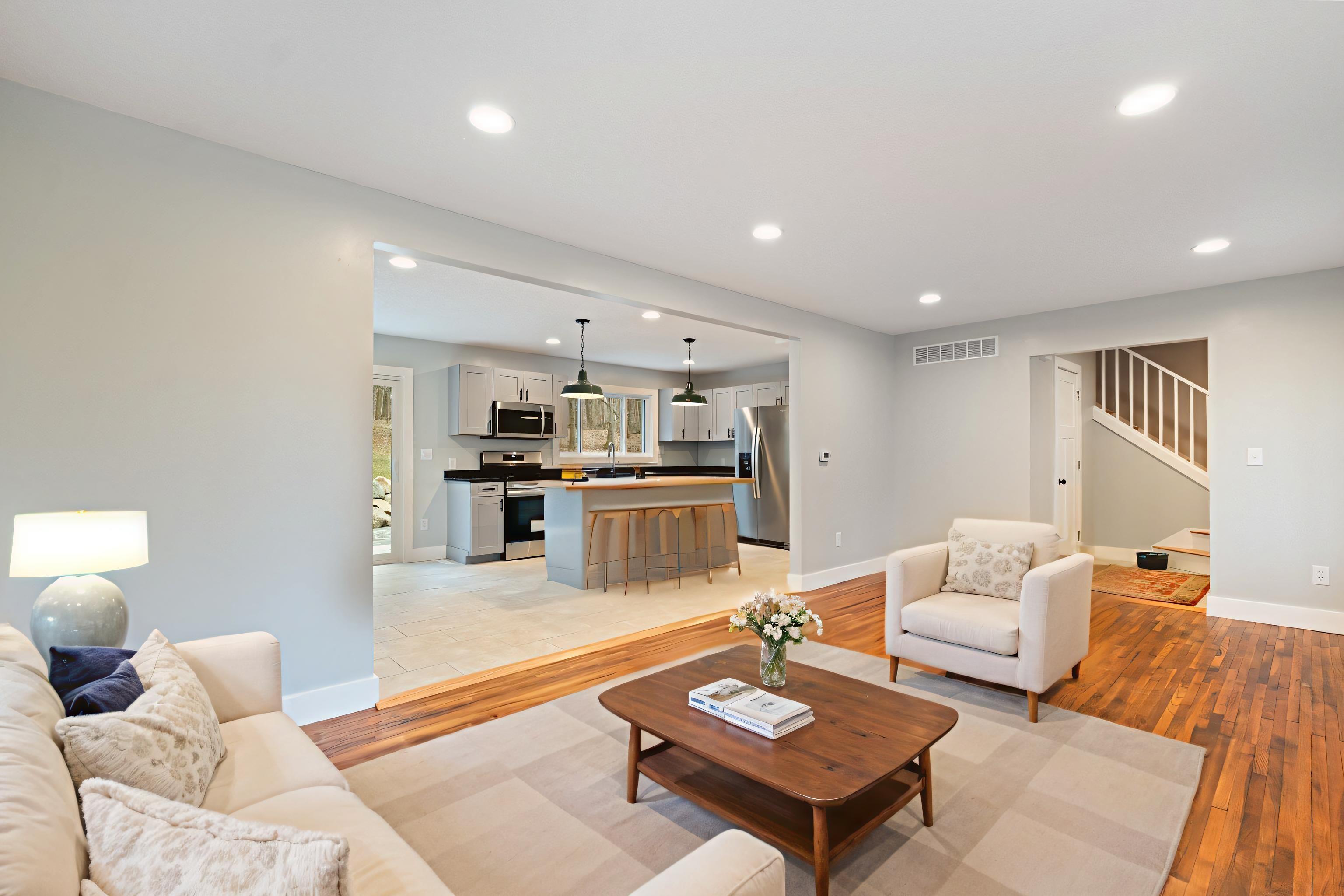 Image 2: Living area featuring light wood-style floors, recessed lighting, and stairway, Living Room Image 2: Living area featuring light wood-style floors, recessed lighting, and stairway, Living Room
