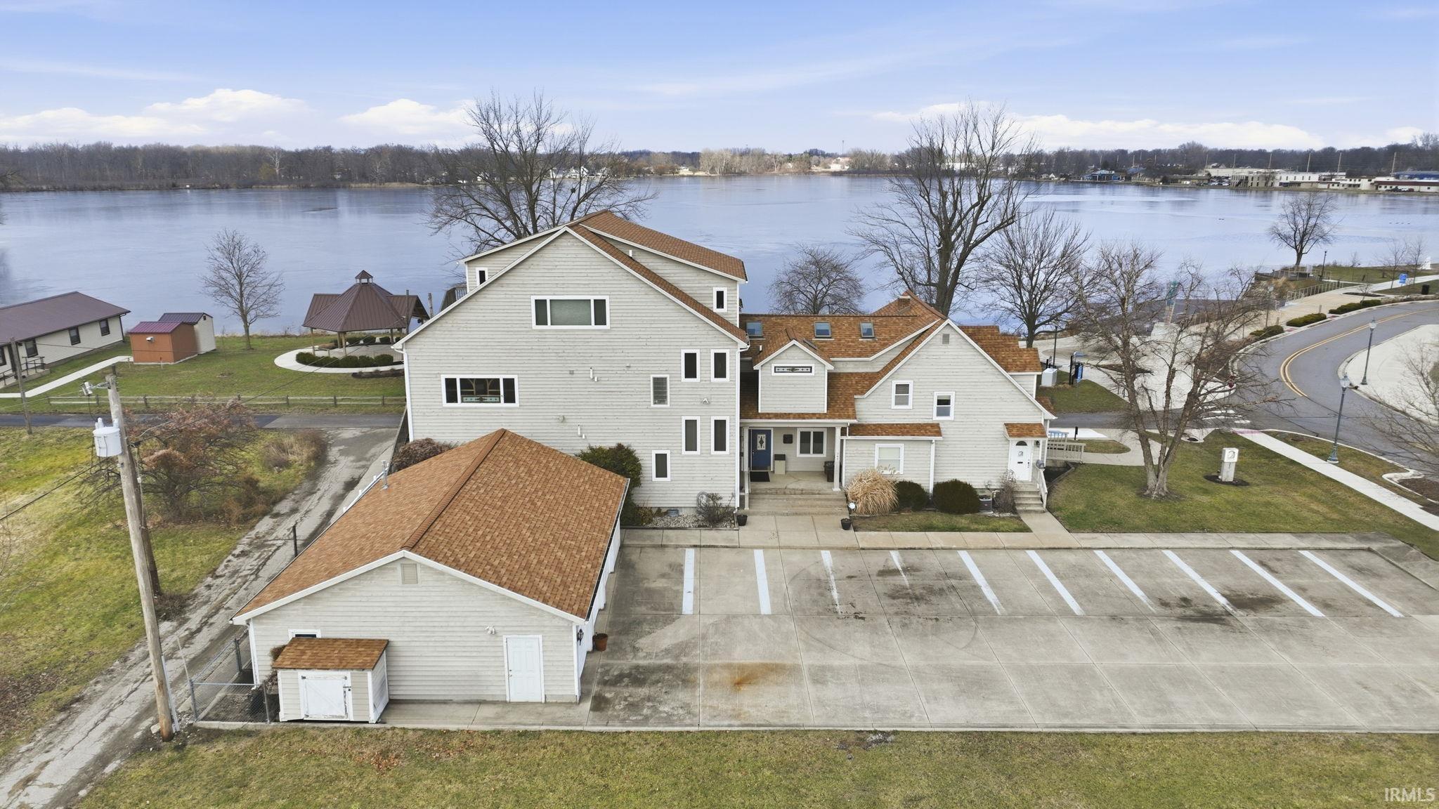 Image 3: Back of property with a water view and a lawn, Back Of Structure