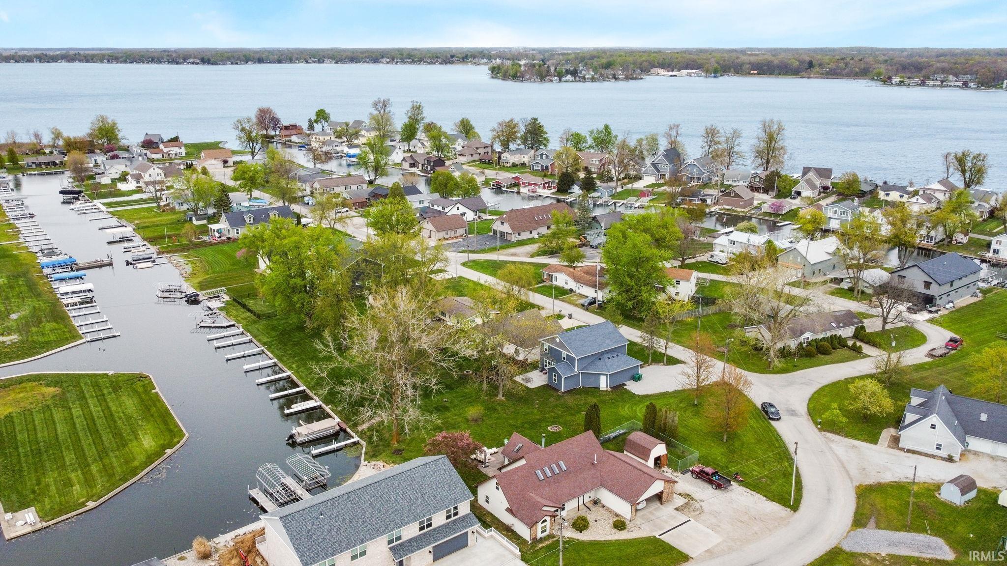 Image 1: Aerial perspective of suburban area featuring a large body of water, Aerial View