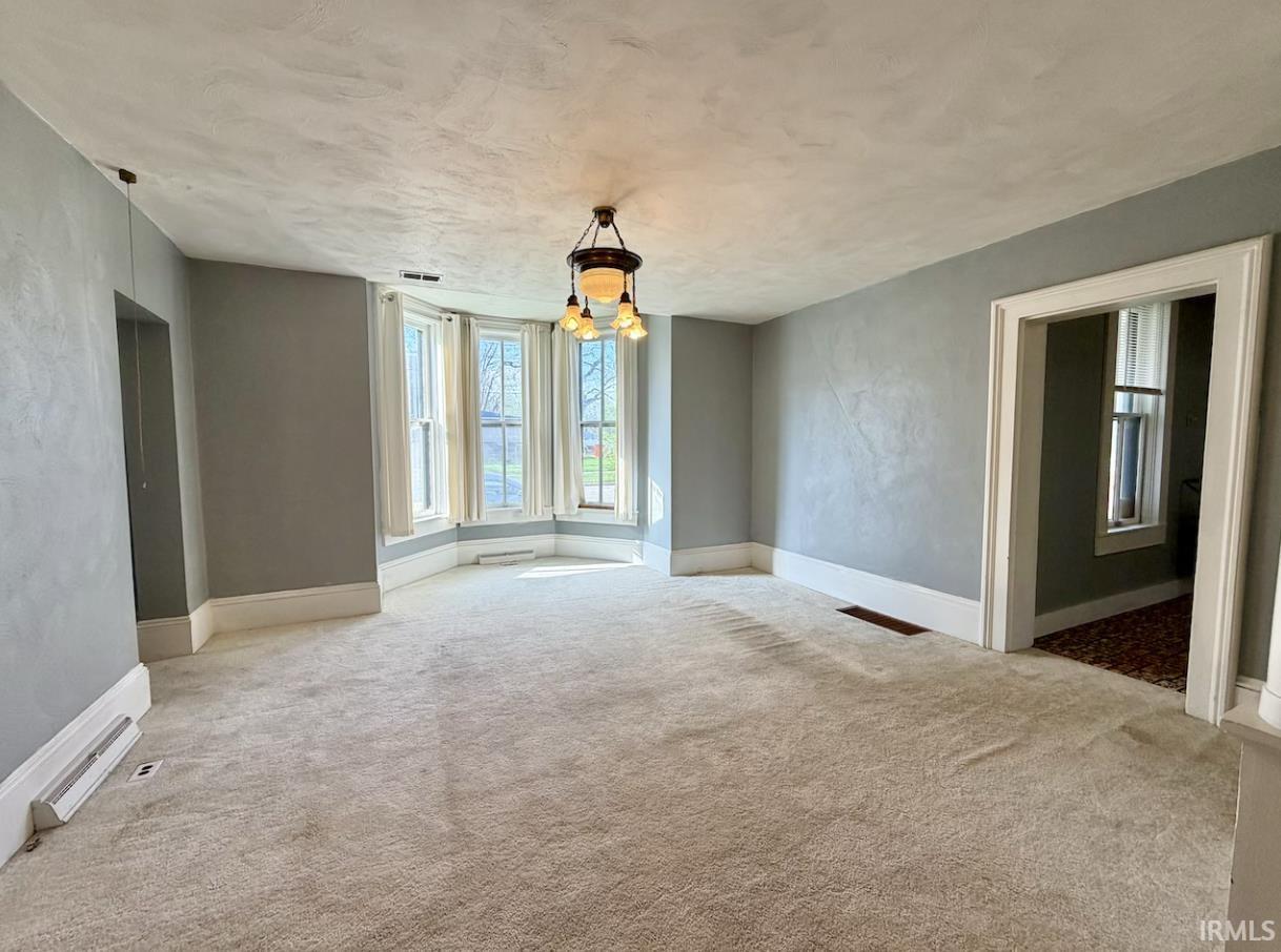 Image 1: Unfurnished room featuring hanging lights and light colored carpet, Other