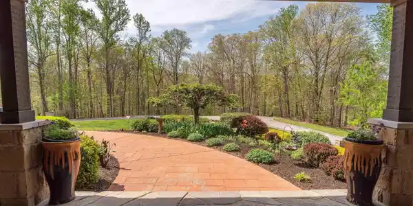 Image 3: Covered stone patio featuring stone columns with wood-finish beams, Front Porch Image 3: Covered stone patio featuring stone columns with wood-finish beams, Front Porch
