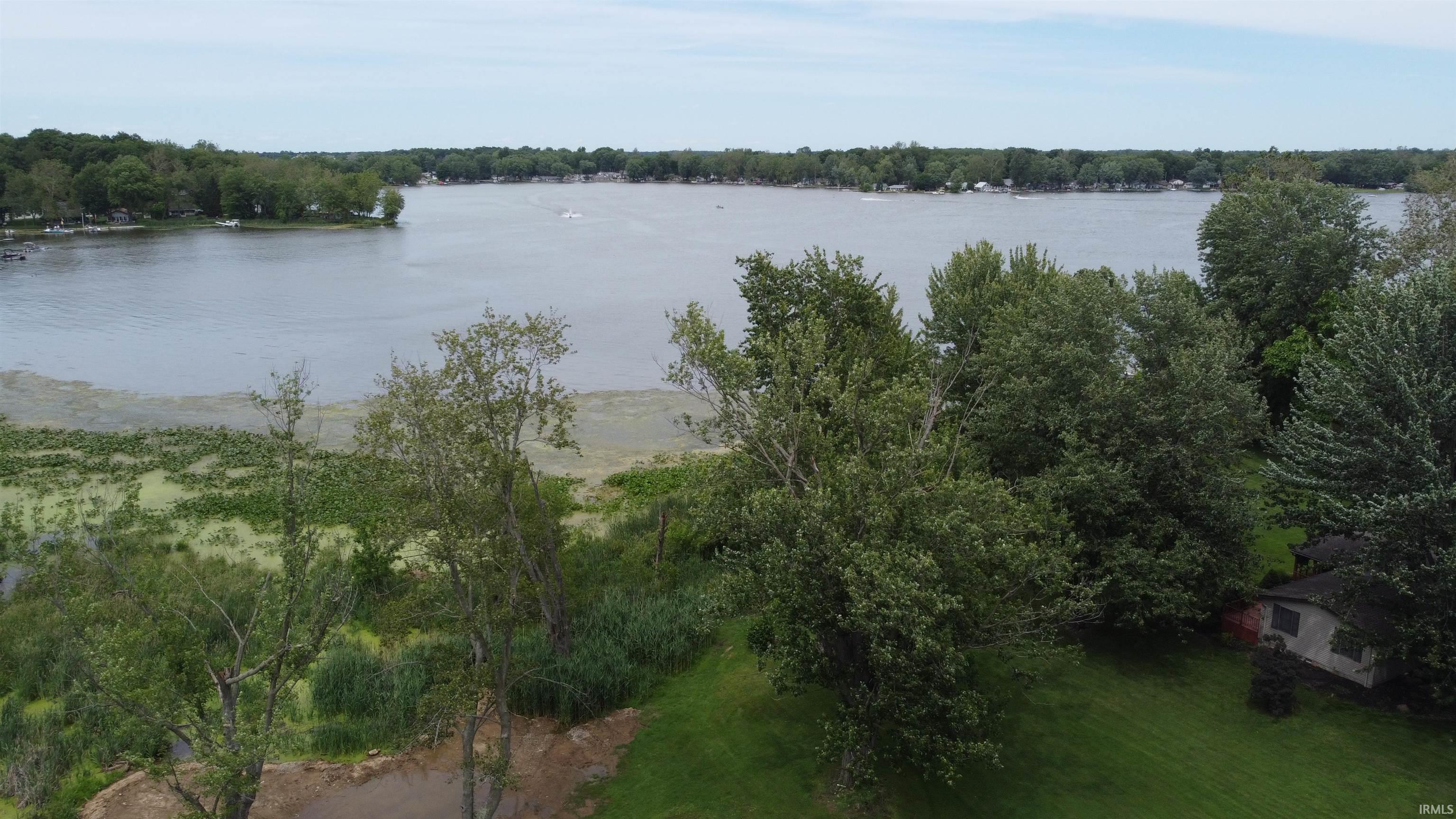 Image 1: Expansive waterfront property featuring a large body of water, mature trees, and lush green landscaping, View Image 1: Expansive waterfront property featuring a large body of water, mature trees, and lush green landscaping, View
