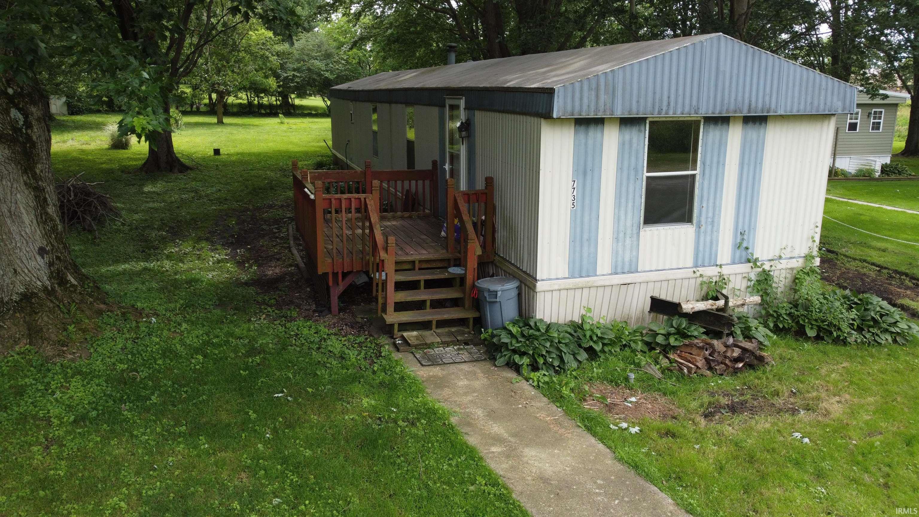 Image 3: Single-story residence featuring white and blue vertical siding, Out Buildings Image 3: Single-story residence featuring white and blue vertical siding, Out Buildings