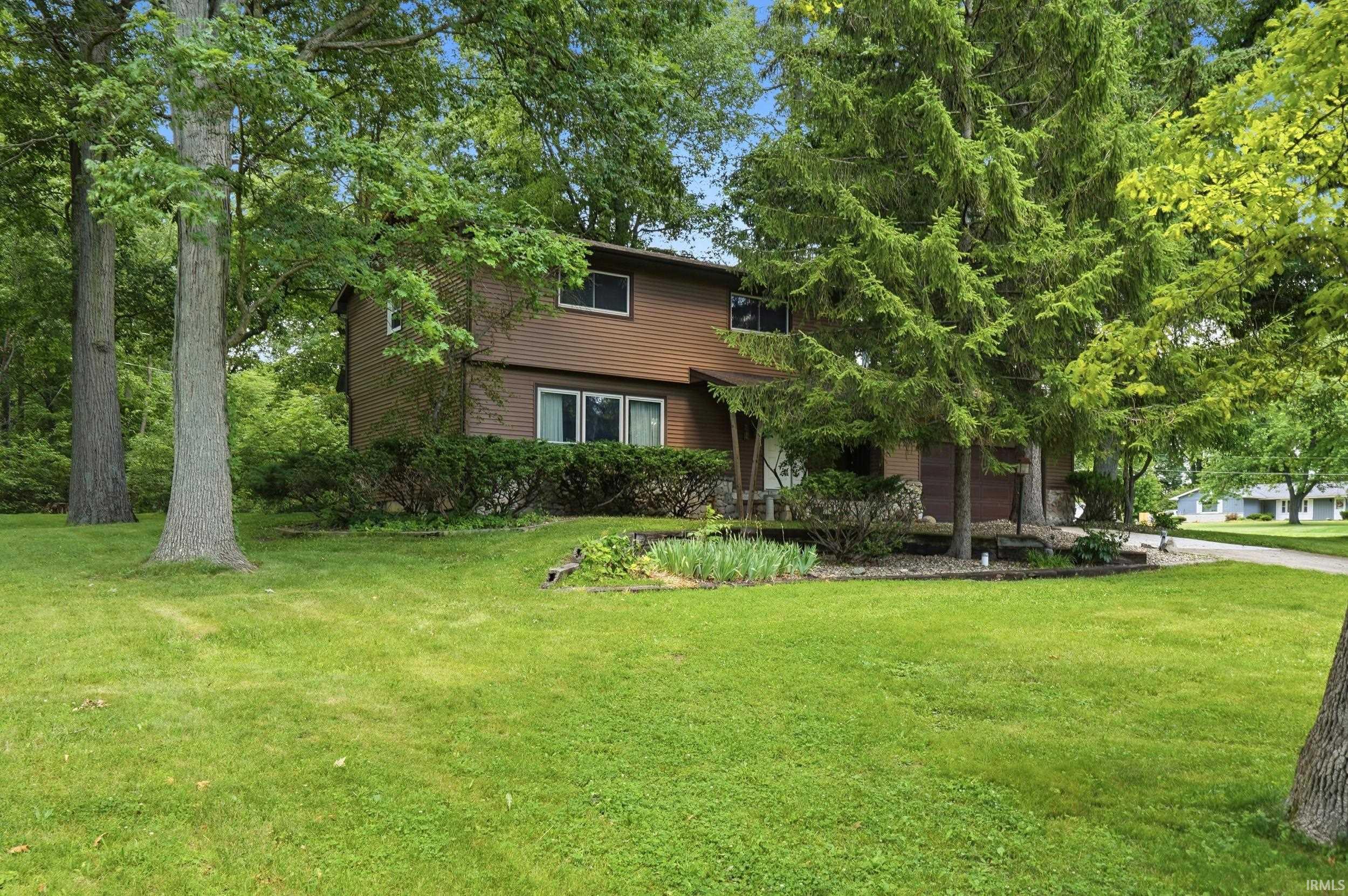 Image 0: Expansive front lawn with mature trees providing natural shade, Front Of Structure Image 0: Expansive front lawn with mature trees providing natural shade, Front Of Structure