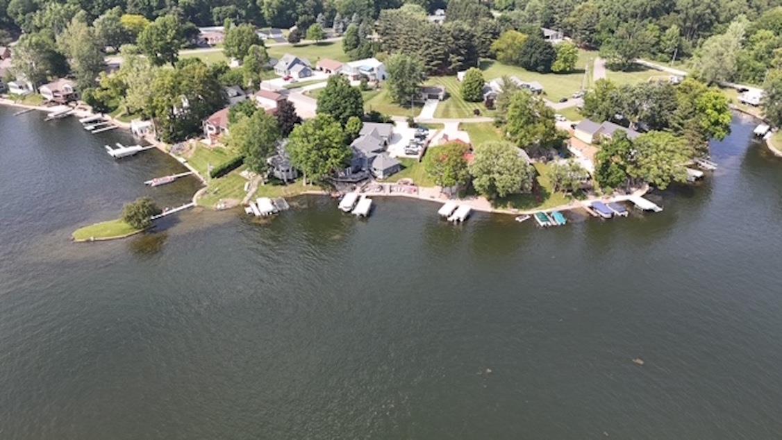 Image 1: Aerial view of property and surrounding area featuring a large body of water and a tree filled landscape, Aerial View Image 1: Aerial view of property and surrounding area featuring a large body of water and a tree filled landscape, Aerial View