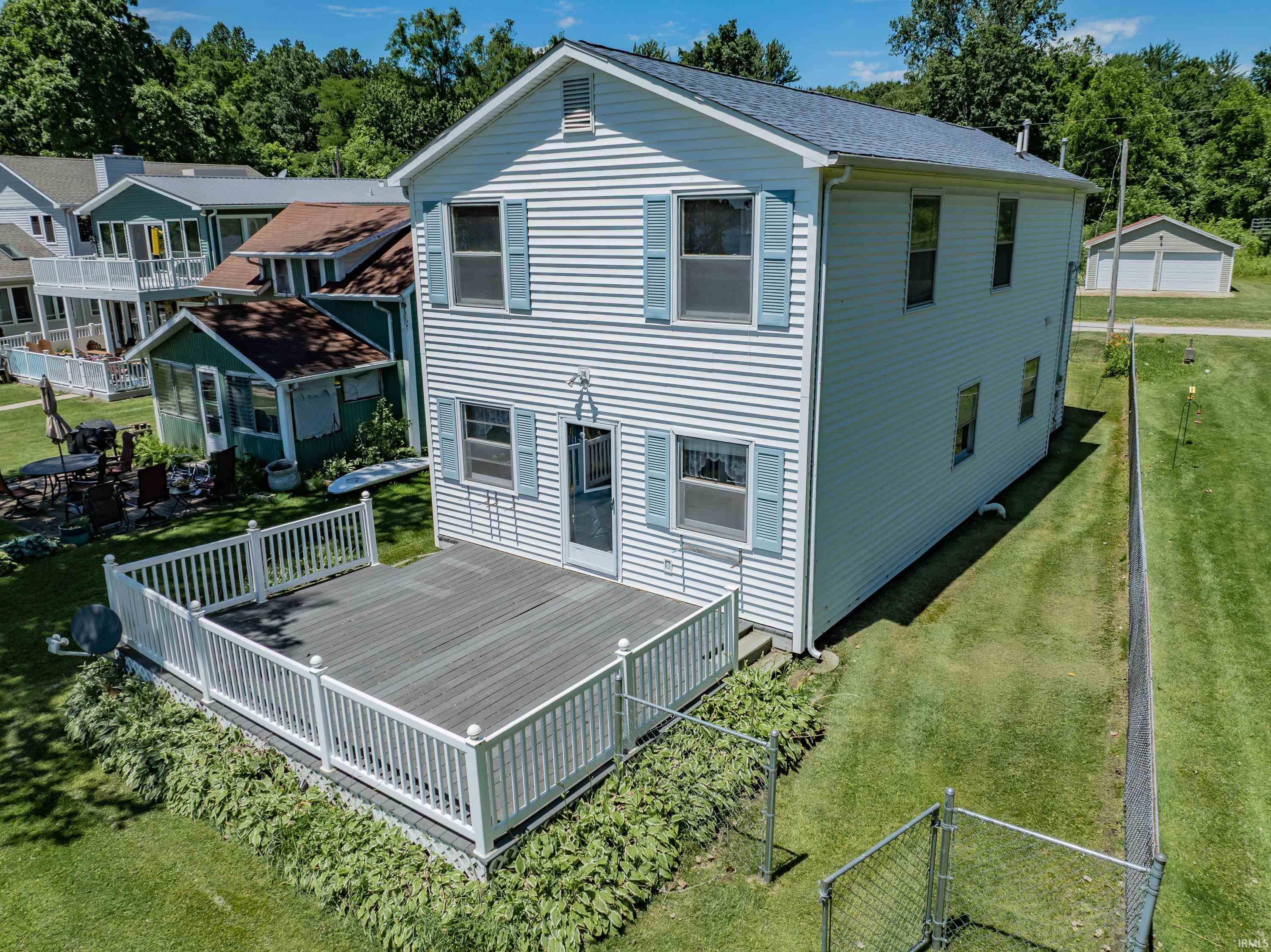 Image 1: White vinyl siding exterior with blue louvered shutters and a charcoal shingle roof, Front of the Structure Image 1: White vinyl siding exterior with blue louvered shutters and a charcoal shingle roof, Front of the Structure