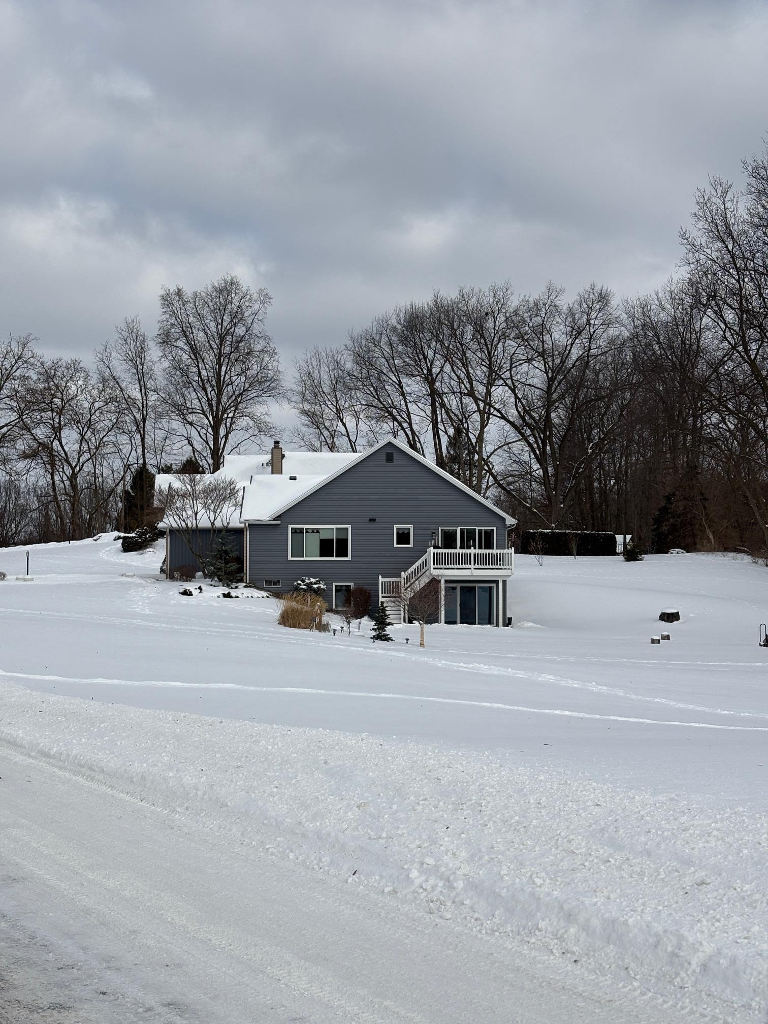 Image 2: View of front facade featuring a chimney and a deck, Front Of Structure