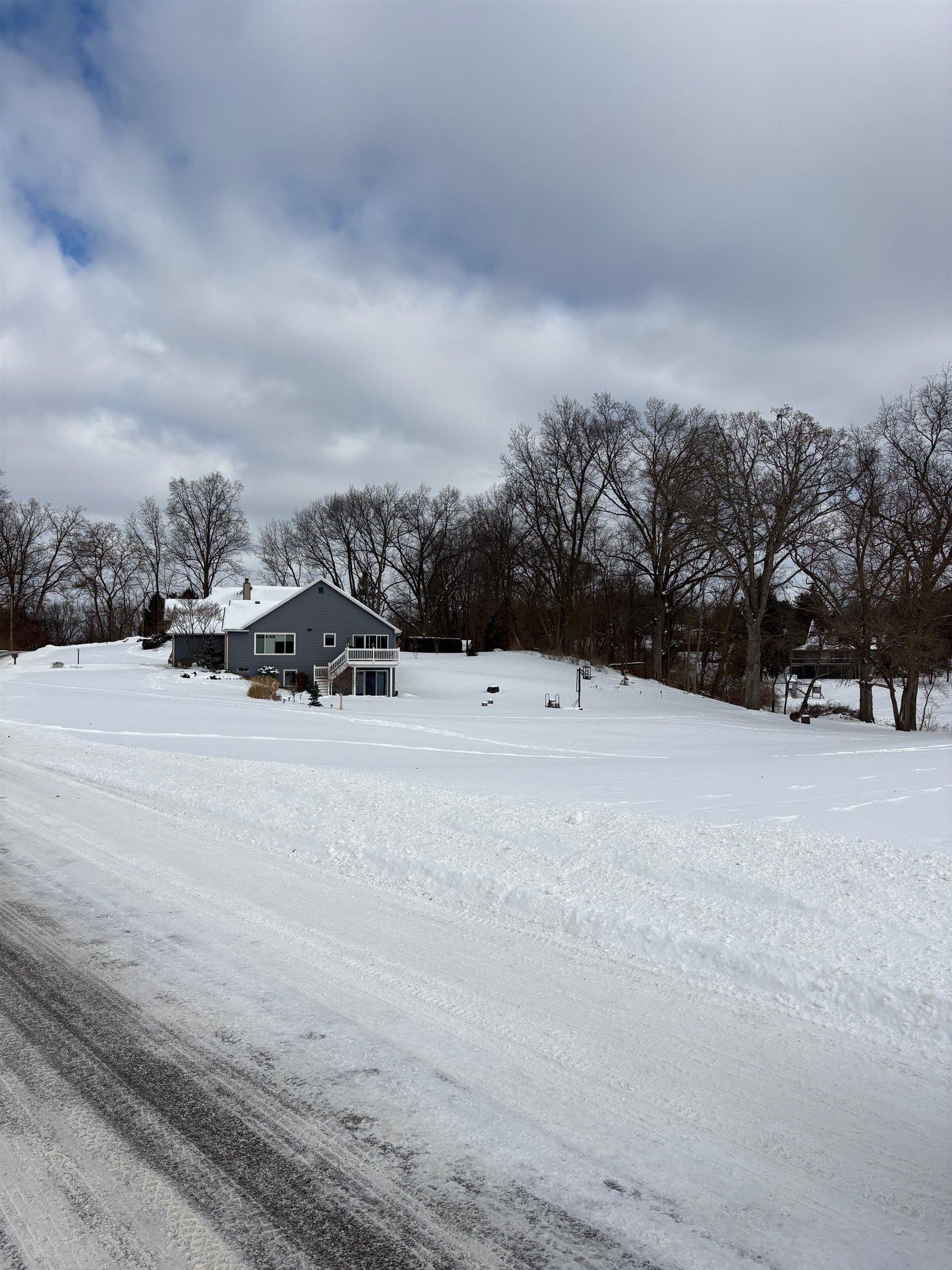 Image 3: View of yard layered in snow, Yard
