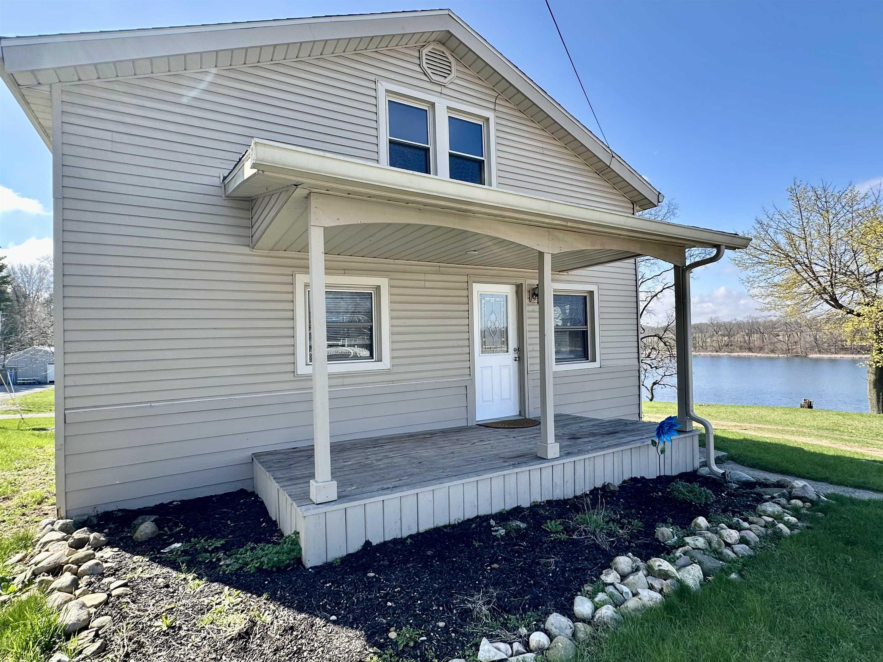 Image 0: View of front of house featuring covered porch and a front lawn, Side Entrance