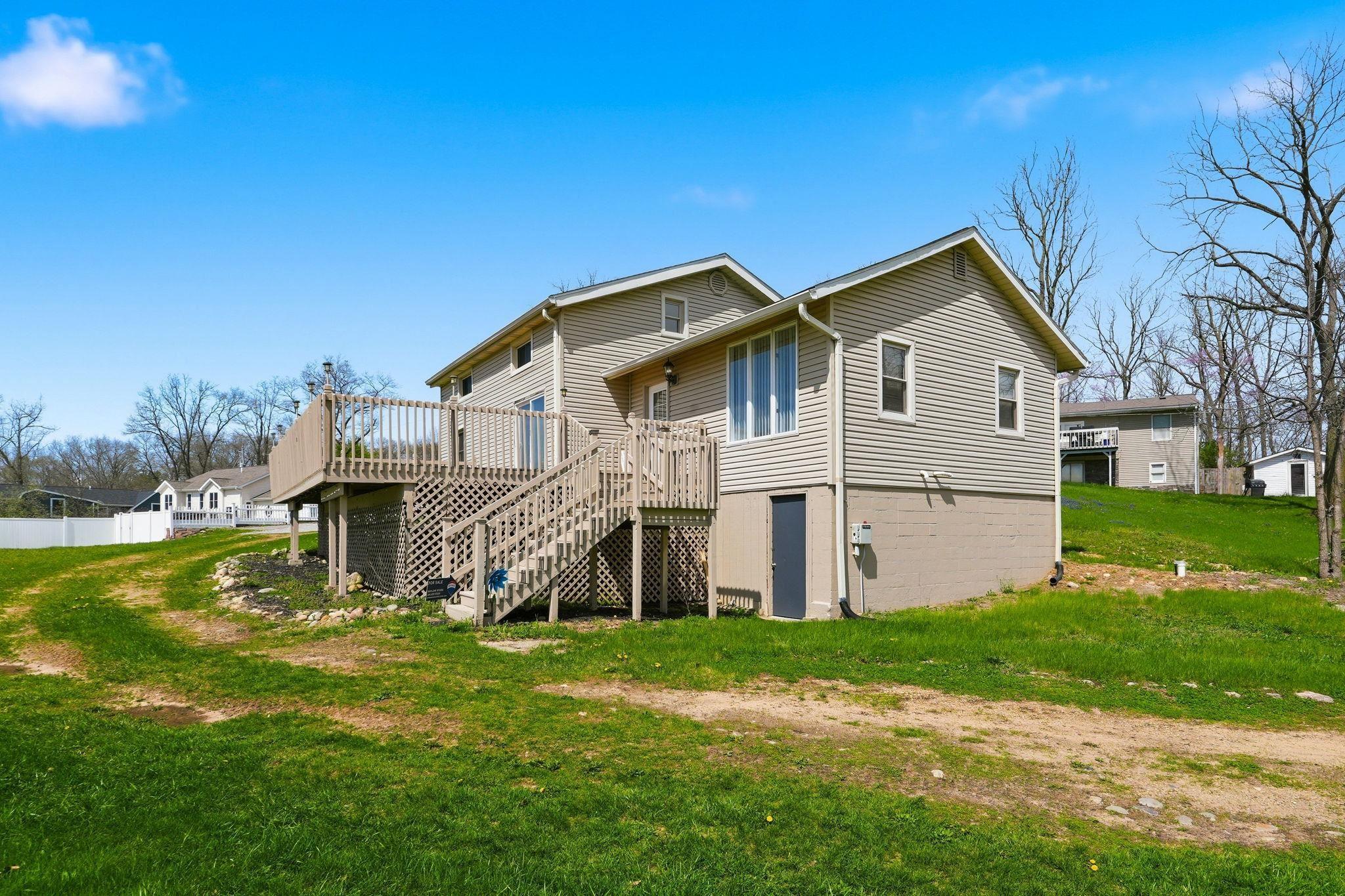 Image 3: Rear view of property with a deck and a lawn, Back Of Structure