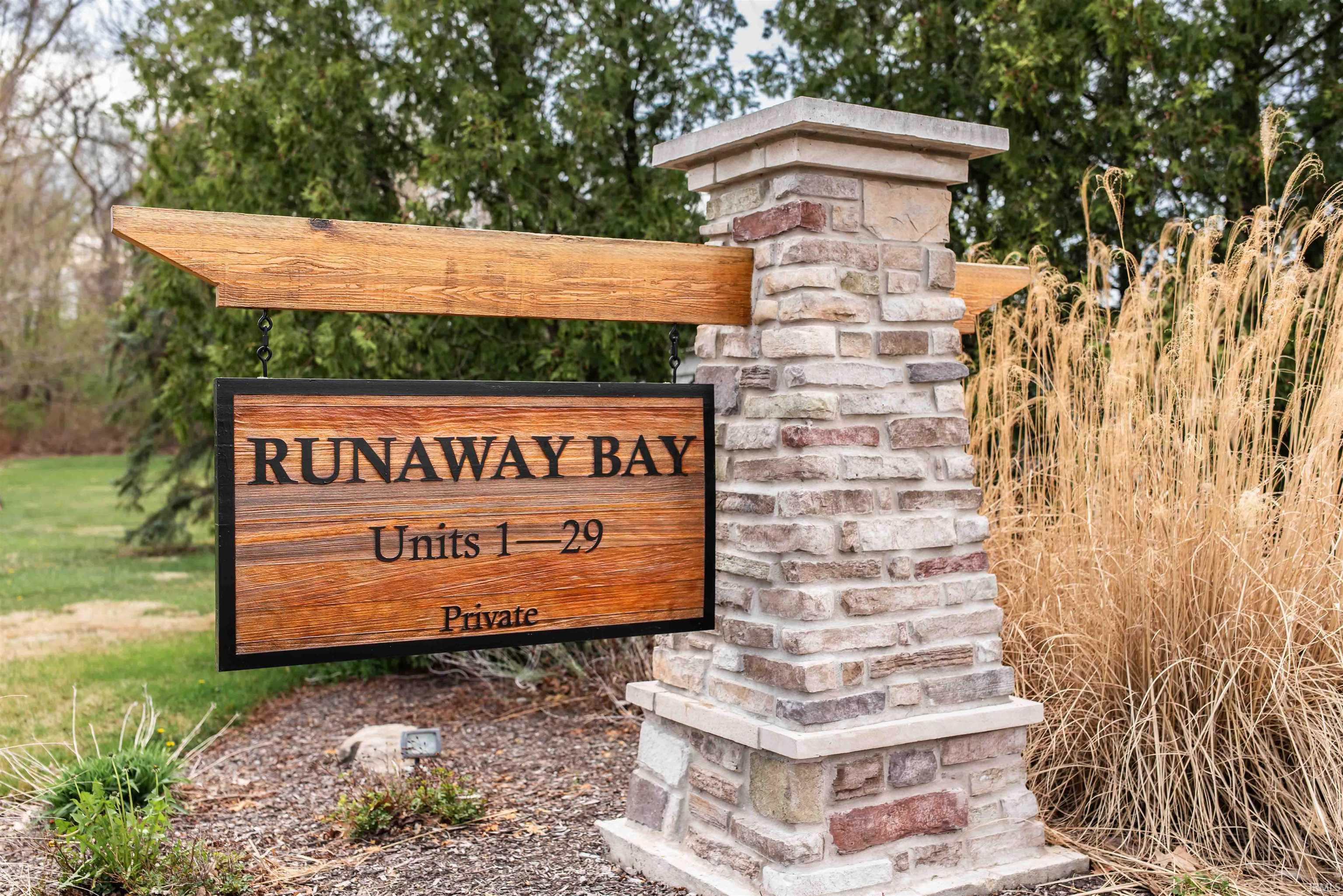Image 1: Stone pillar entrance featuring a wood-finish sign with wrought iron detailing, Community Image 1: Stone pillar entrance featuring a wood-finish sign with wrought iron detailing, Community
