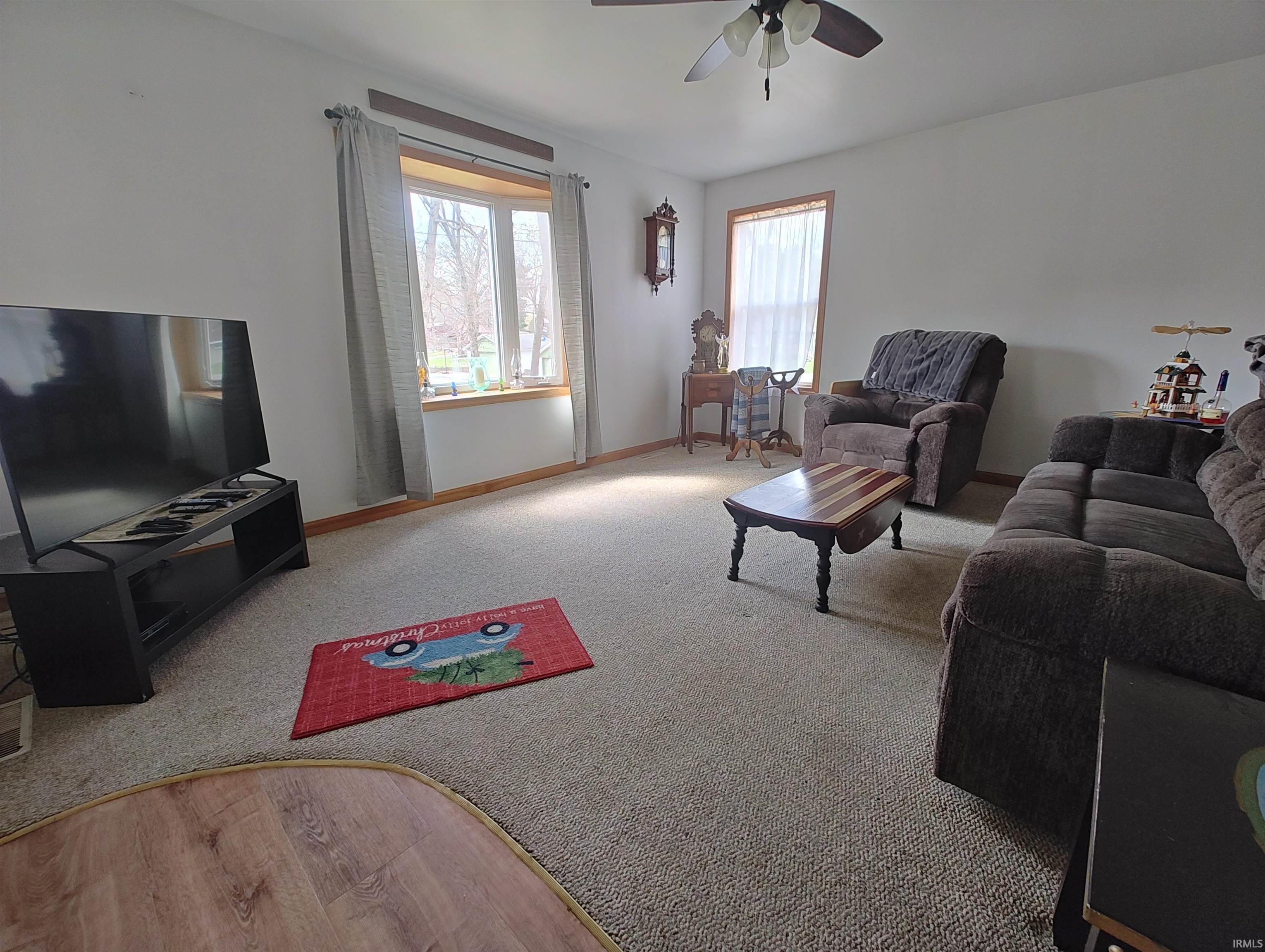 Image 1: Living room with ceiling fan, wood finished floors, and carpet, Living Room