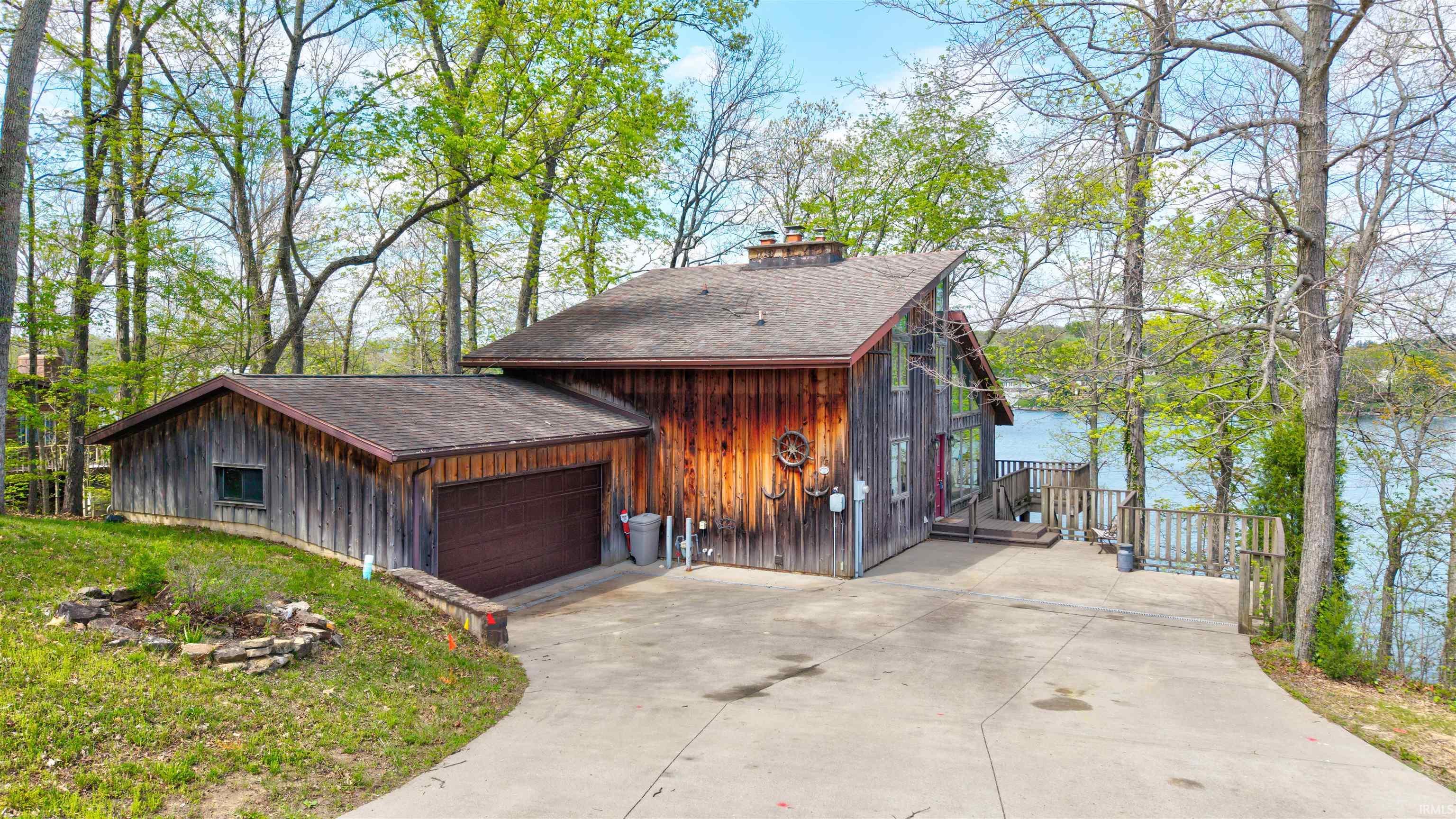 Image 1: View of front of property with roof with shingles, a garage, a chimney, and driveway, Front Of Structure Image 1: View of front of property with roof with shingles, a garage, a chimney, and driveway, Front Of Structure