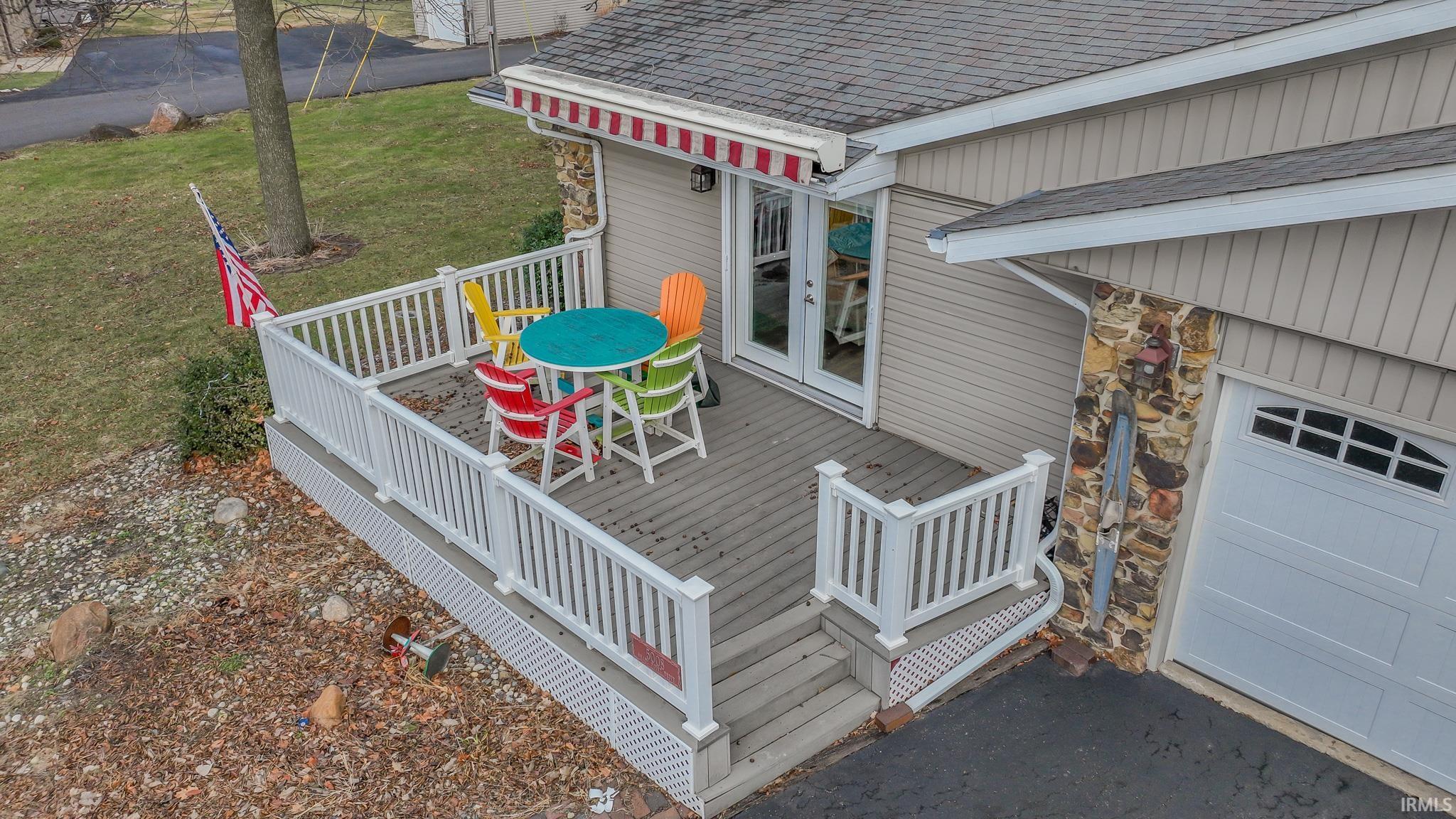 Image 3: Wooden deck featuring a garage, french doors, and a lawn, Deck