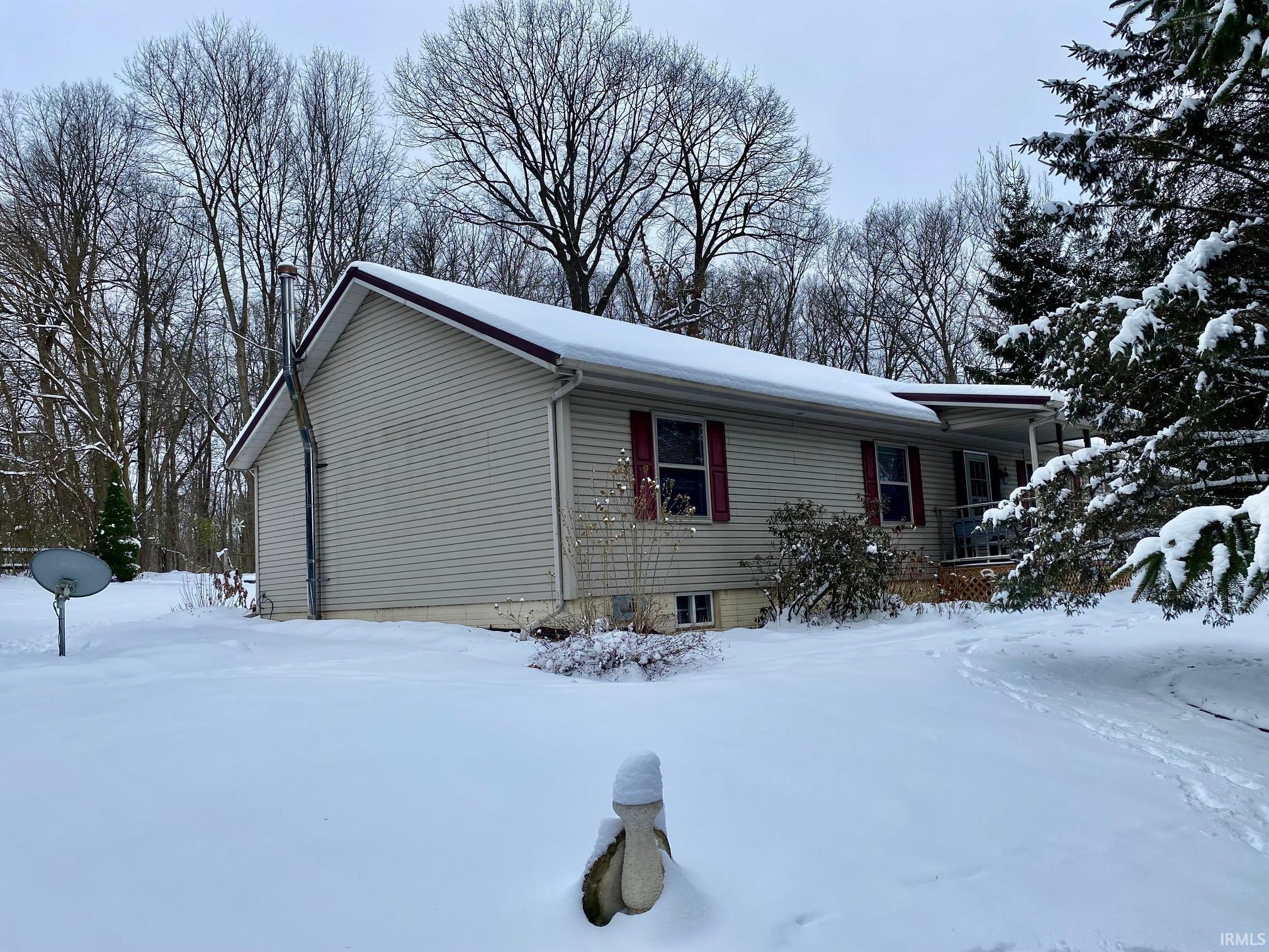 Image 0: View of snow covered exterior featuring a porch, Side Of Structure