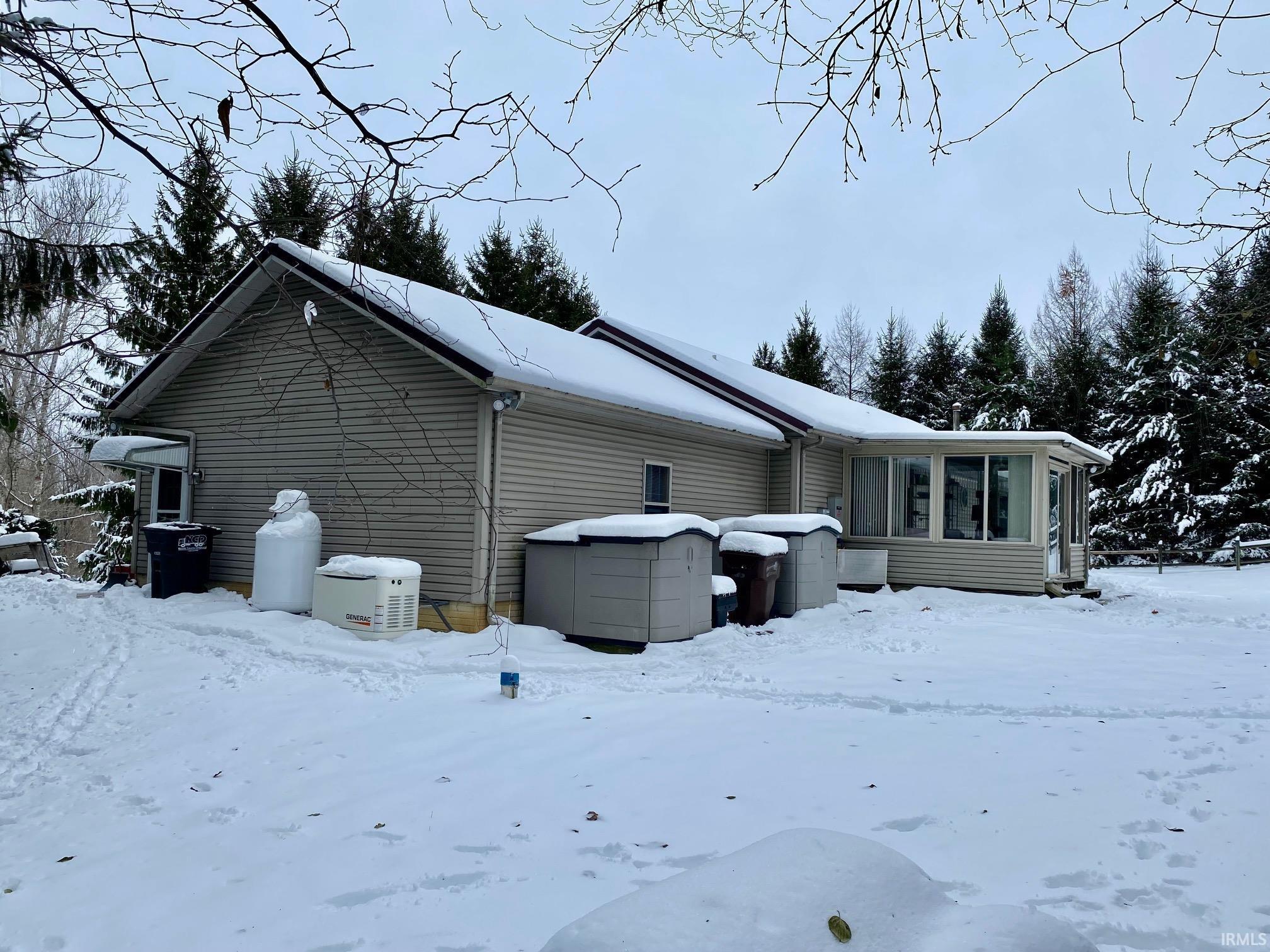 Image 3: View of snow covered exterior featuring a sunroom, Side Of Structure