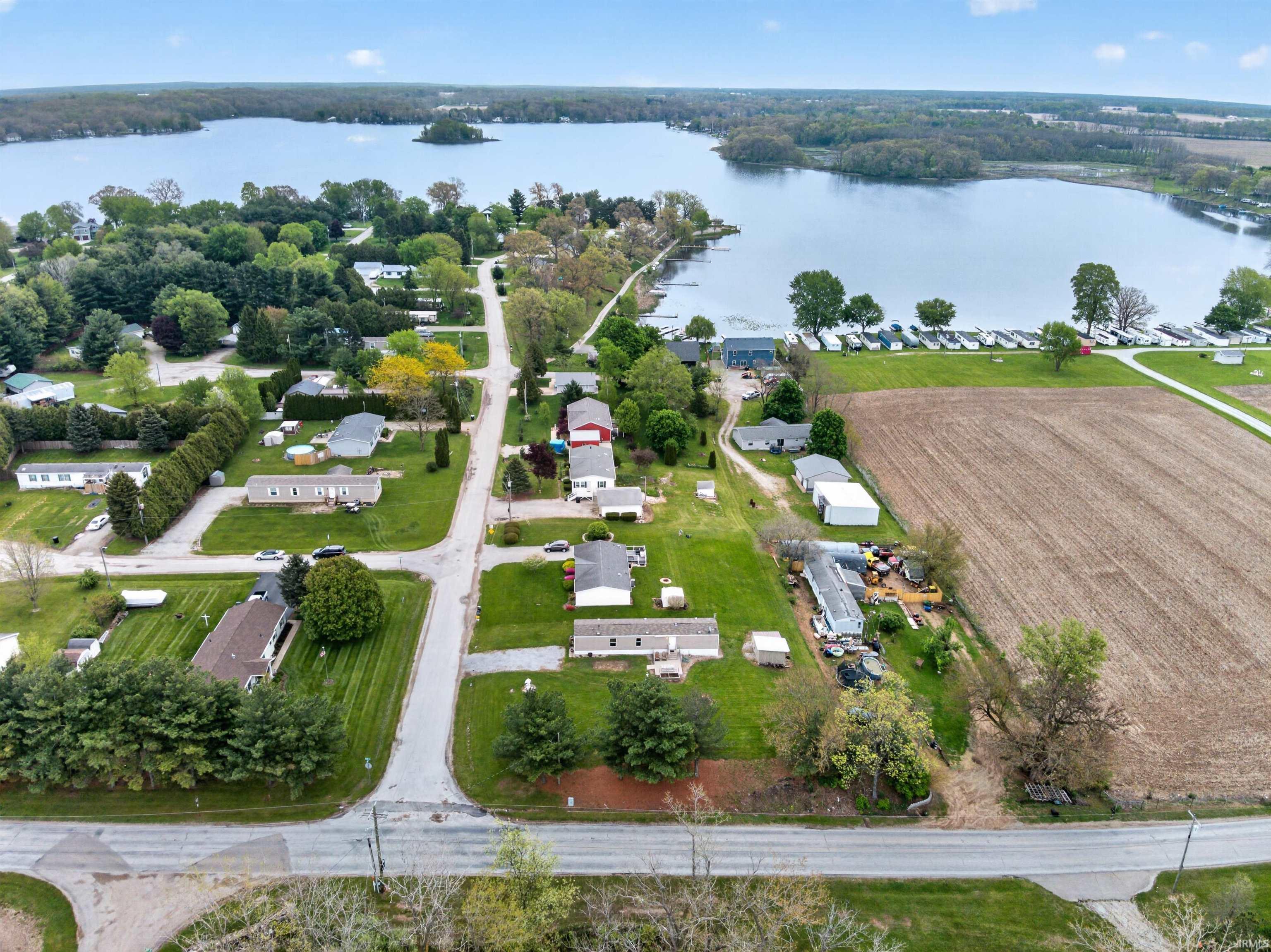 Image 3: Aerial perspective showcasing a waterfront community with direct lake access, Aerial View Image 3: Aerial perspective showcasing a waterfront community with direct lake access, Aerial View