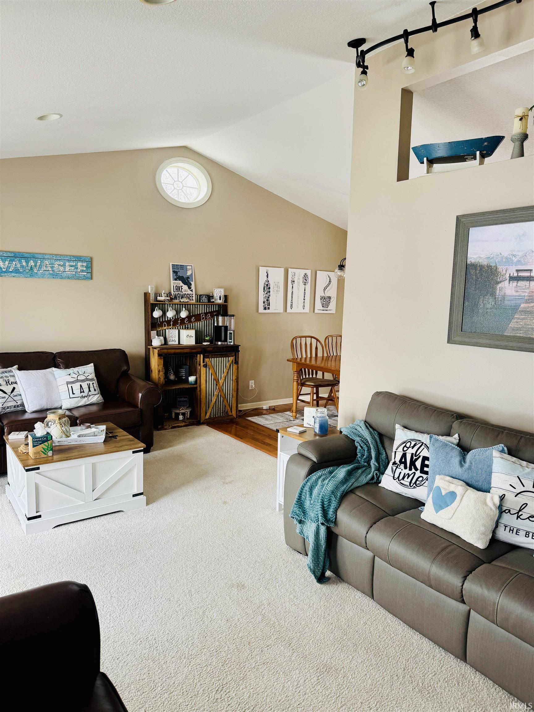 Image 2: Carpeted living room featuring vaulted ceiling and track lighting, Living Room