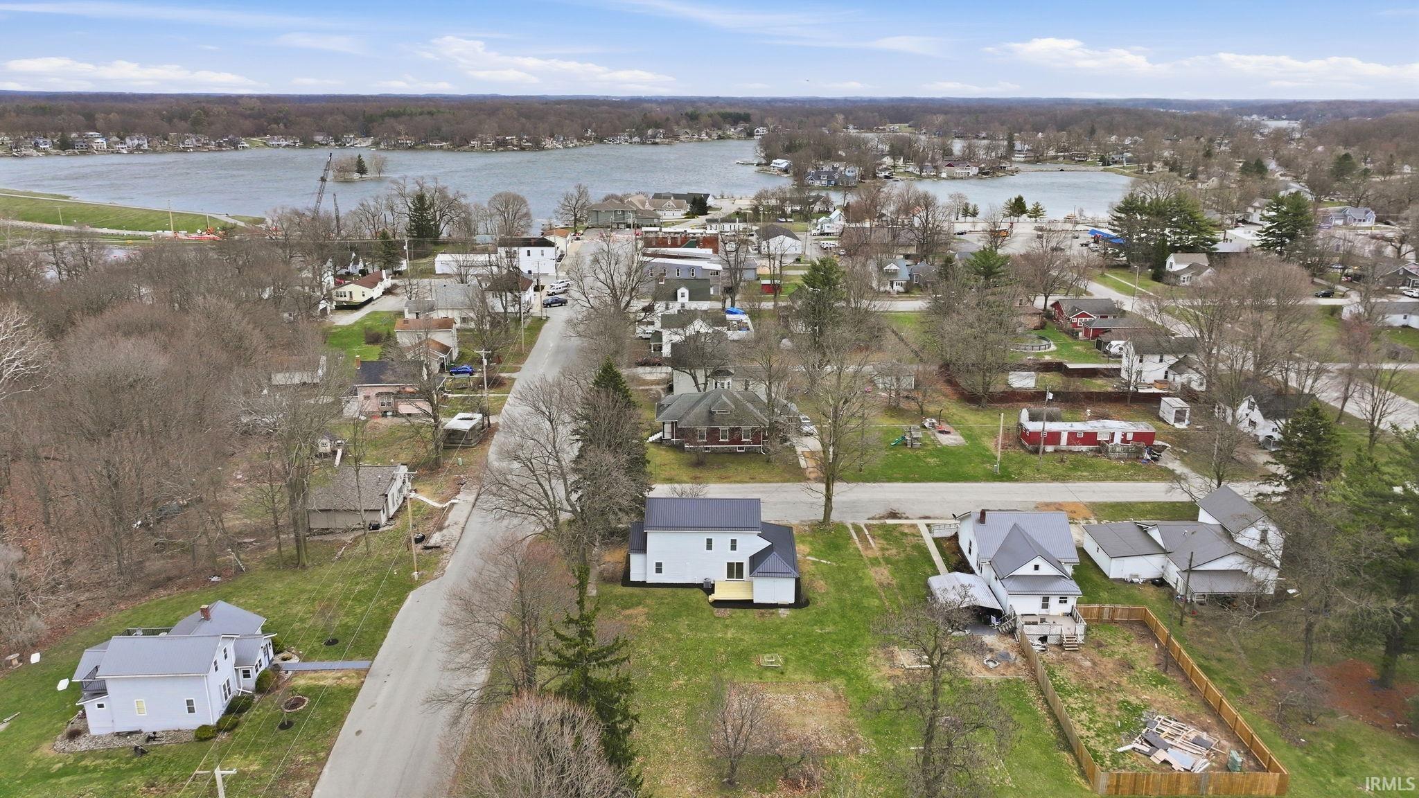 Image 4: Aerial perspective of suburban area with a large body of water, Aerial View