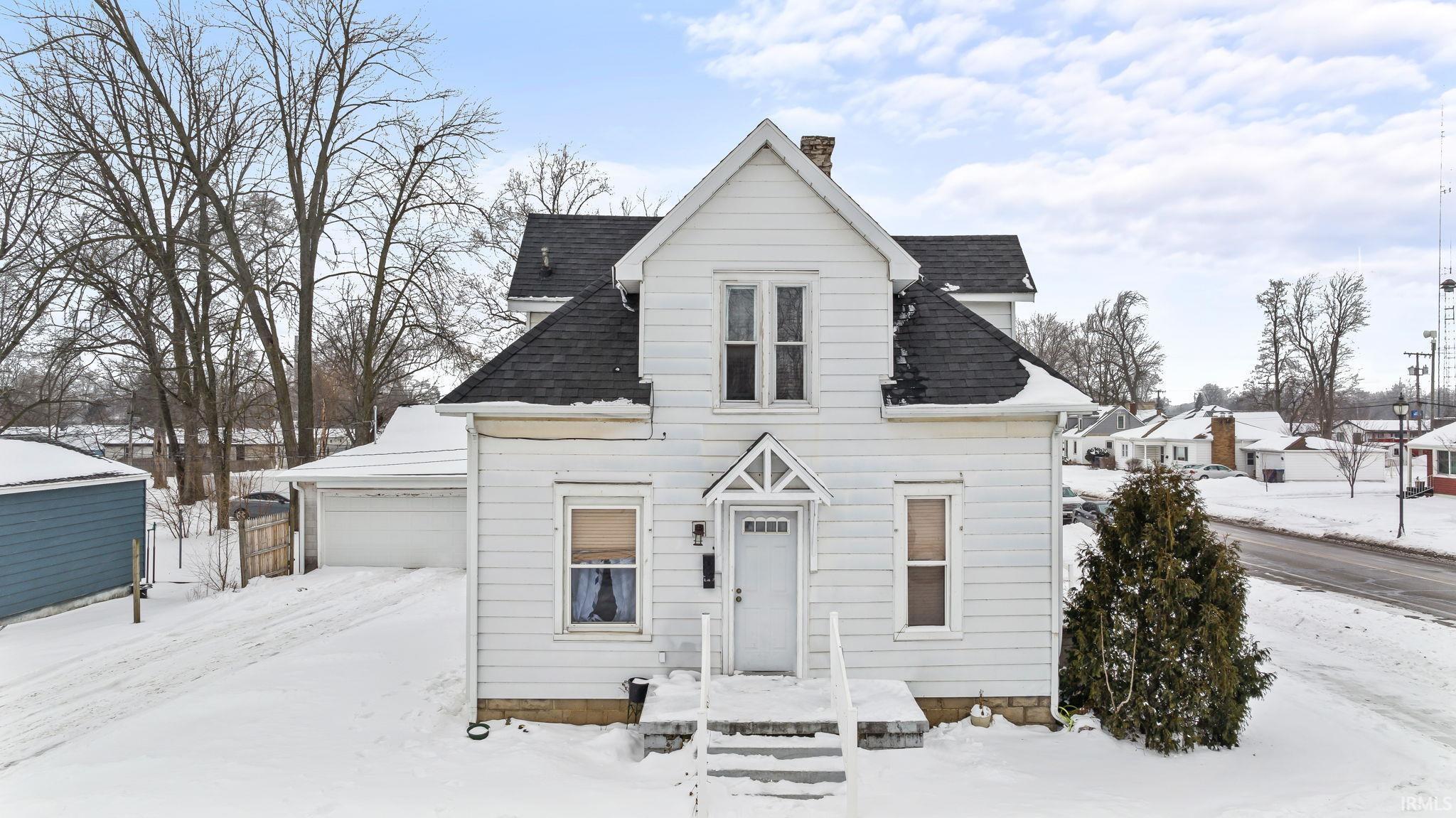 Image 1: View of front of home with a shingled roof and a chimney, Front Of Structure