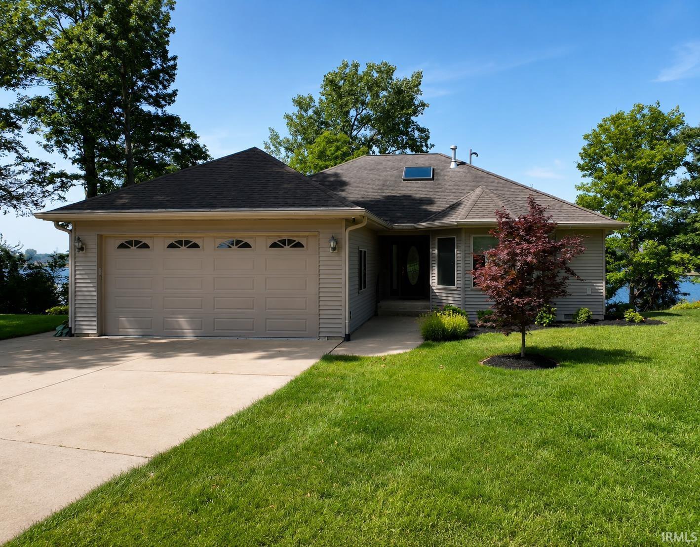 Image 2: Ranch-style residence featuring light-colored siding, a dark roof, and an attached three-car garage, Front Of Structure Image 2: Ranch-style residence featuring light-colored siding, a dark roof, and an attached three-car garage, Front Of Structure