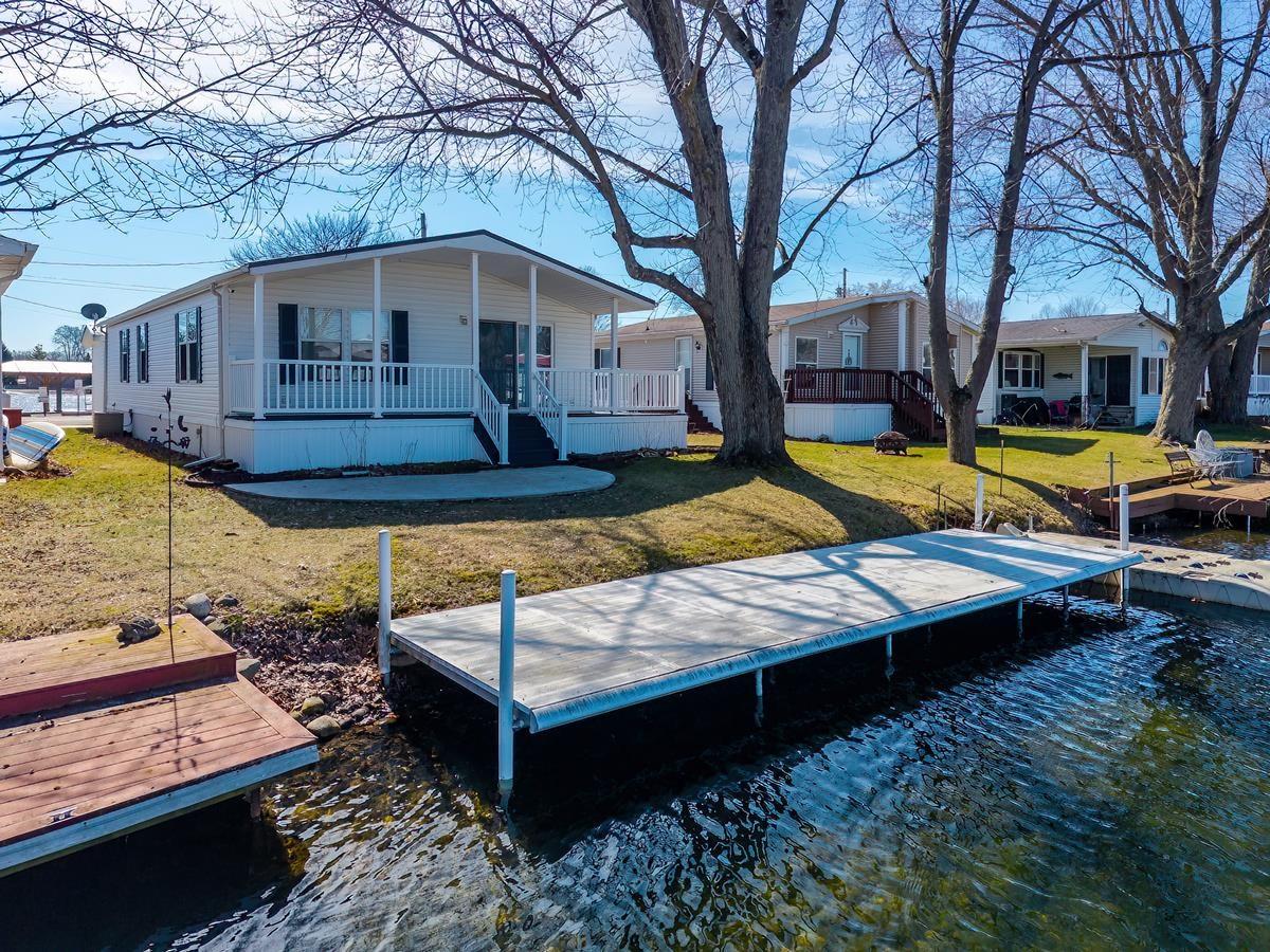 Image 0: Dock area with a lawn, a water view, and covered porch, Dock Image 0: Dock area with a lawn, a water view, and covered porch, Dock