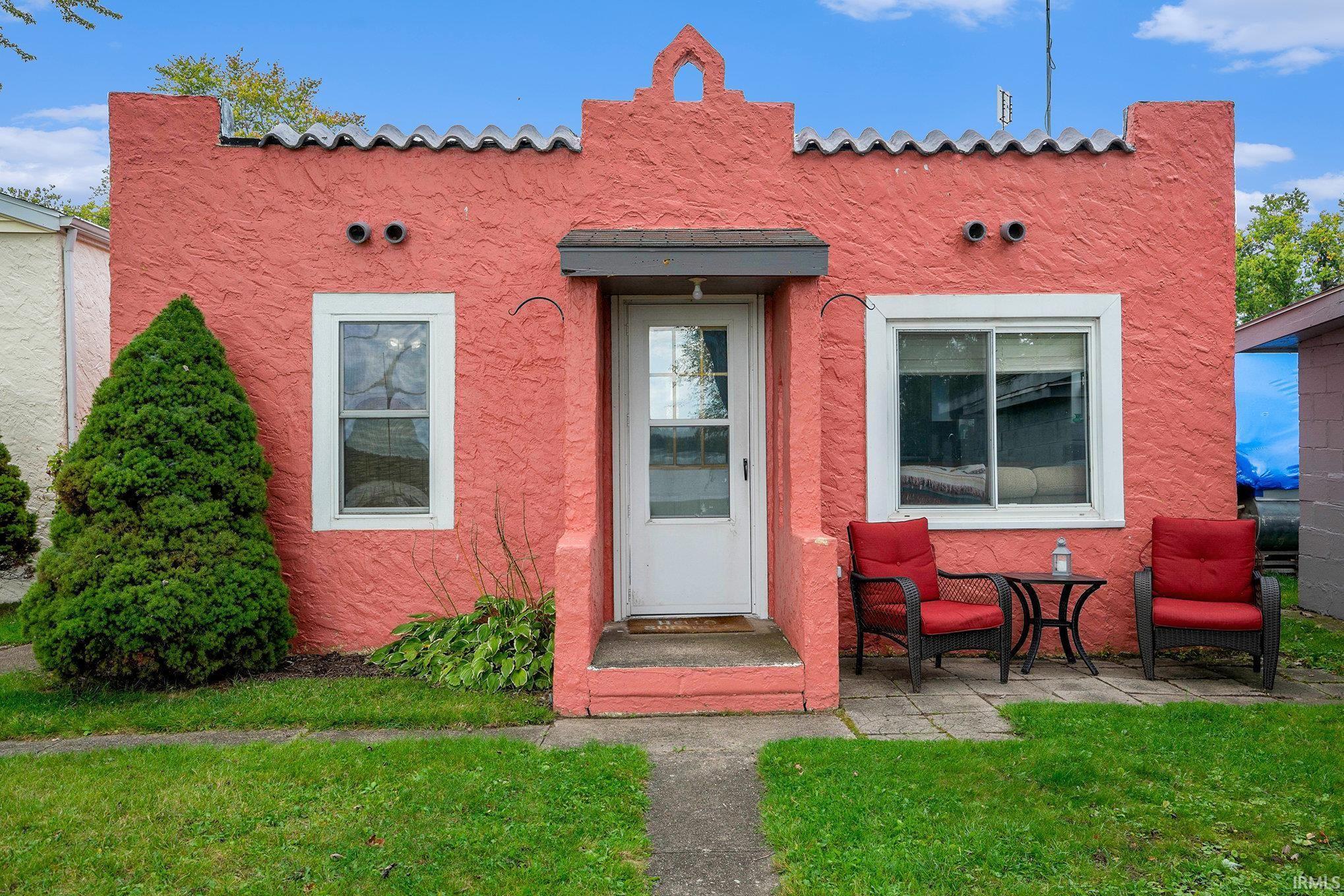 Image 0: View of front of property with a front yard, stucco siding, and a tiled roof, Front Of Structure