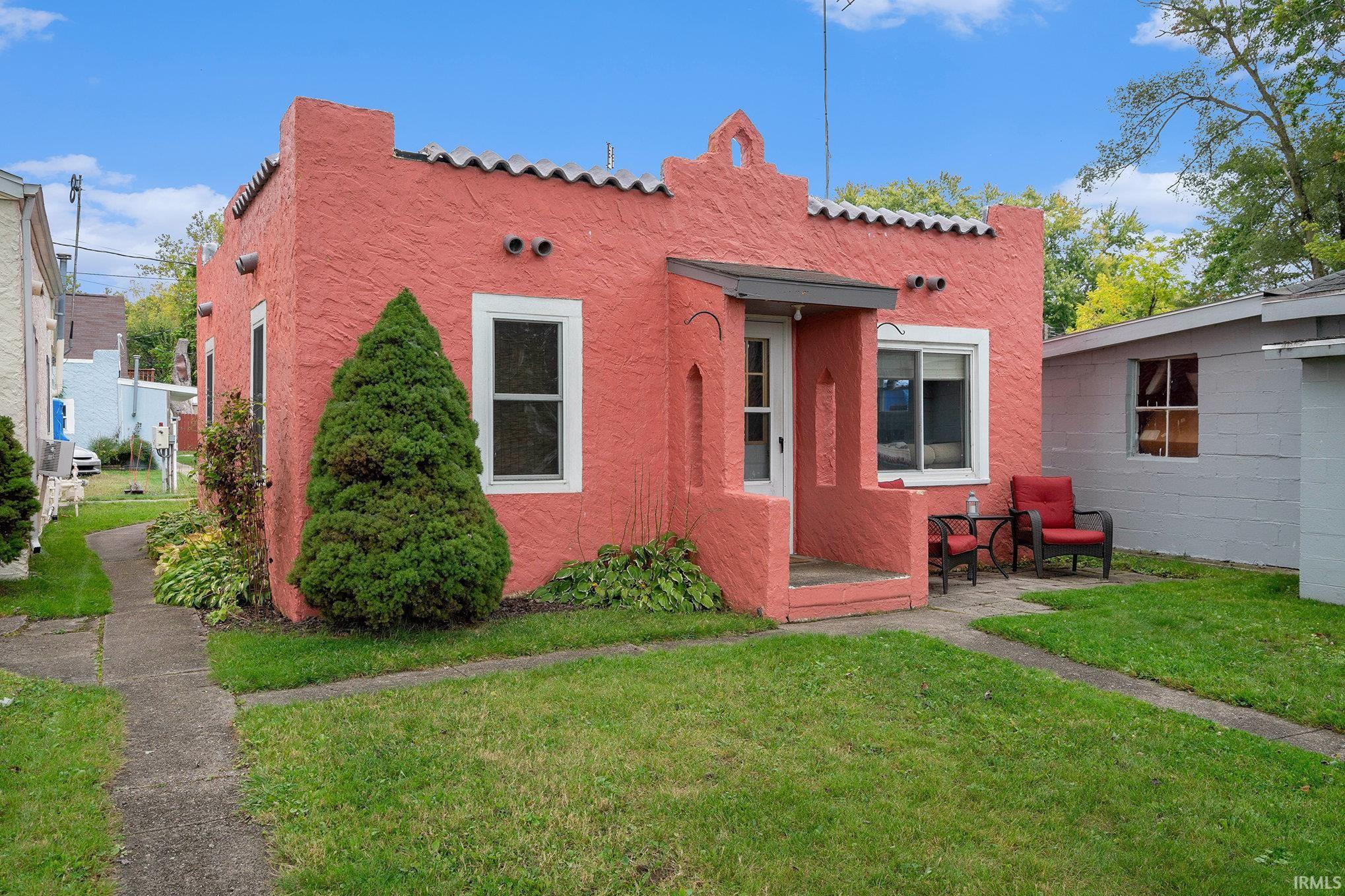 Image 1: Back of house featuring a yard, stucco siding, and a tiled roof, Back Of Structure