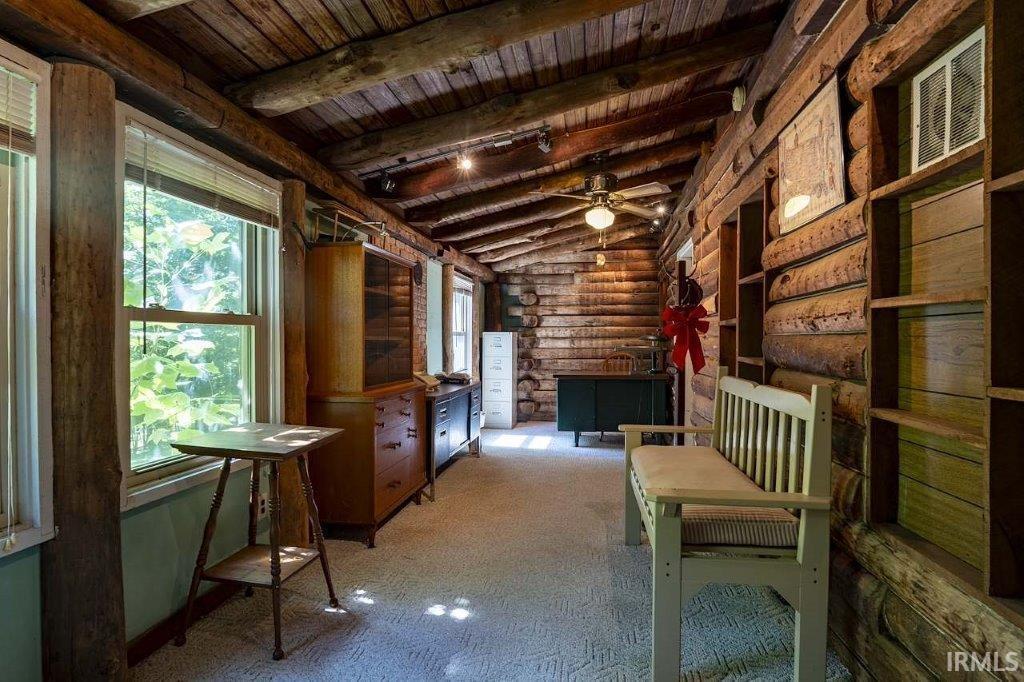 Image 1: Rustic interior hallway featuring exposed log walls, a wood-planked vaulted ceiling, and recessed lighting, Den Image 1: Rustic interior hallway featuring exposed log walls, a wood-planked vaulted ceiling, and recessed lighting, Den